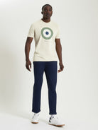 Signature Target Tee – Crew Neck Regular Fit with Target Print in Beige worn with navy pants and white sneakers.