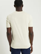 Signature Target Tee – back view of a man wearing an organic cotton crew neck t-shirt in beige.