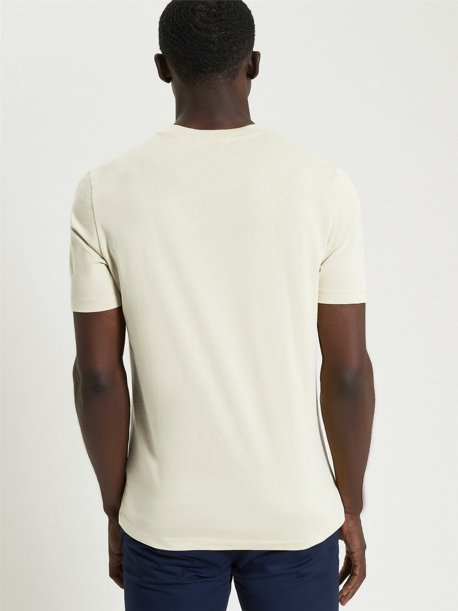 Signature Target Tee – back view of a man wearing an organic cotton crew neck t-shirt in beige.