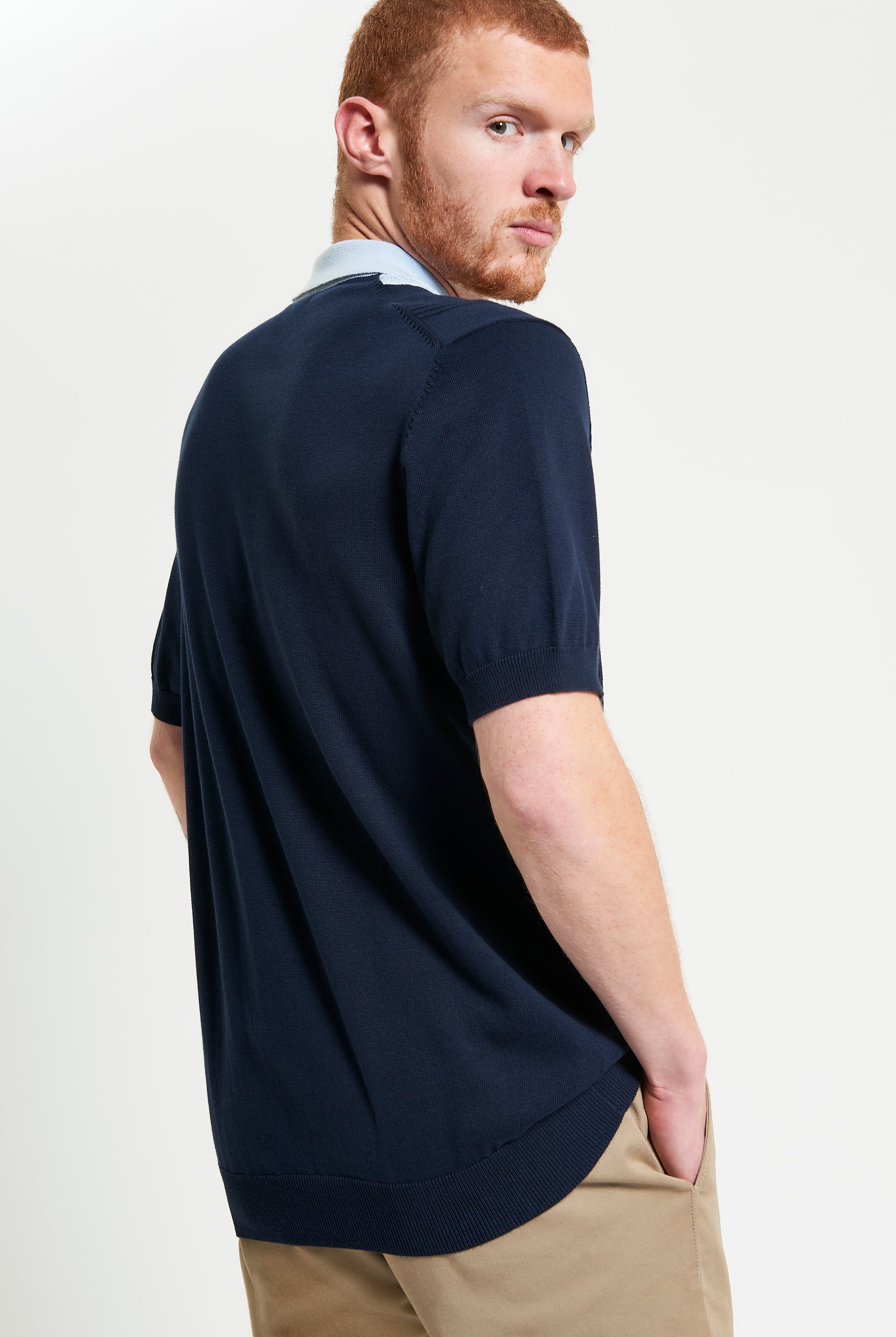 Textured Block Stripe Polo – navy blue short sleeve polo with raised block-stripe texture, featuring a three-button placket.