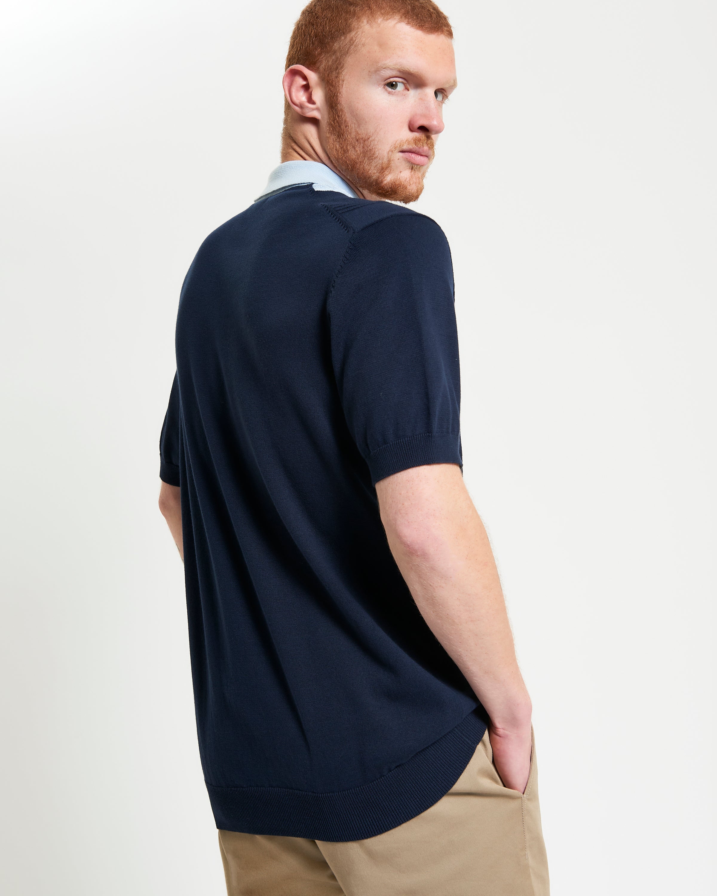 Textured Block Stripe Polo – navy blue short sleeve polo with raised block-stripe texture, featuring a three-button placket.