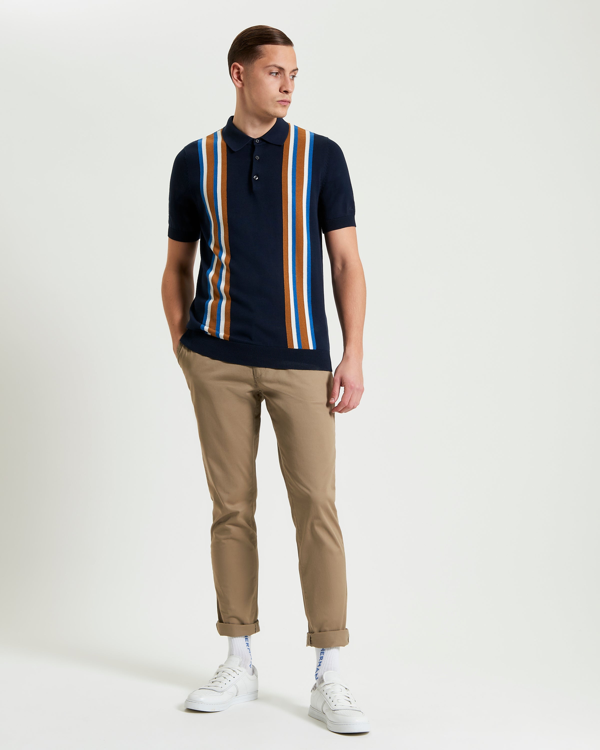 Vertical Stripe Polo – navy and multi-color stripes, worn with chinos for a smart casual look.