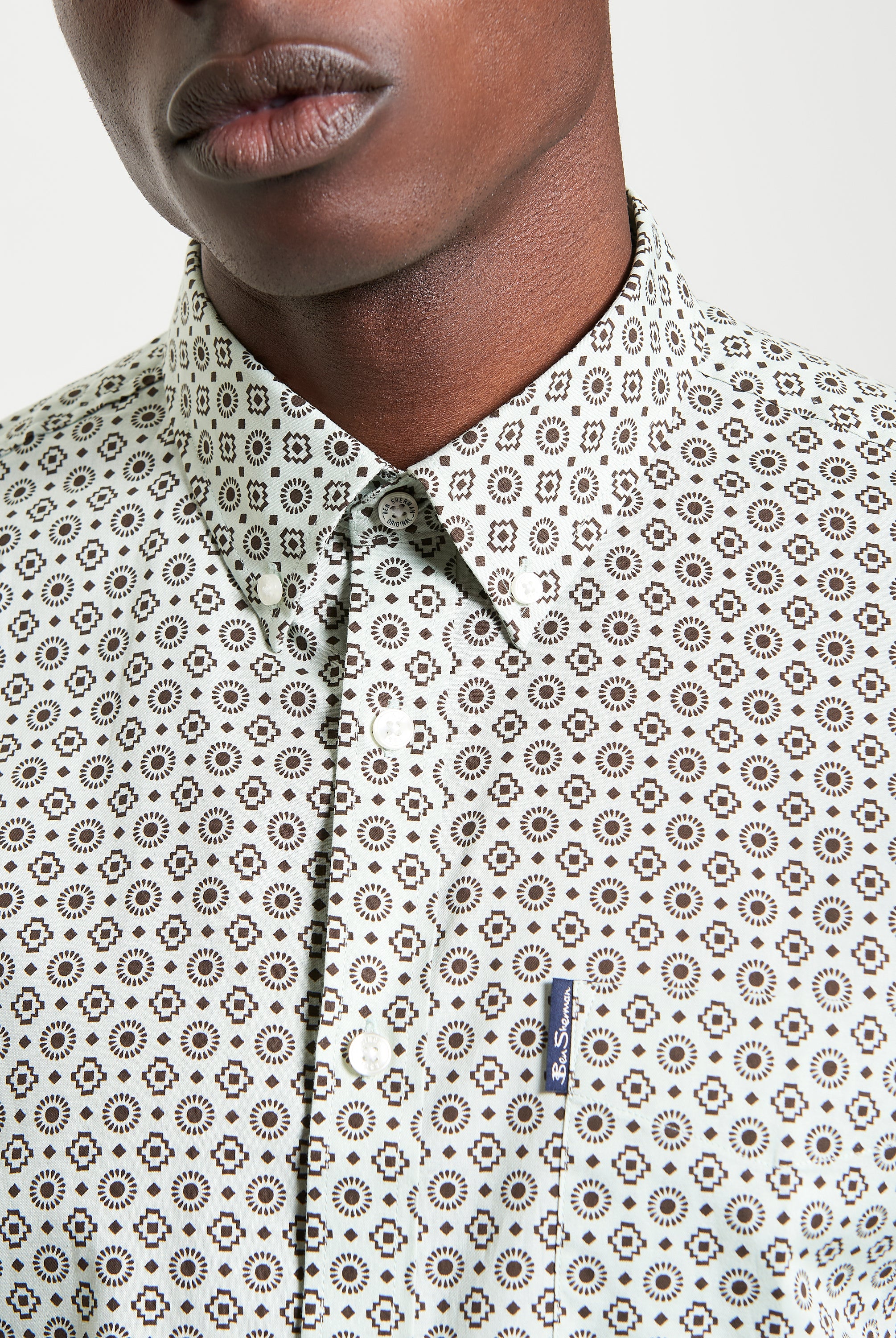 Block Geo Print short sleeve shirt close-up featuring button-down collar and curved hem.