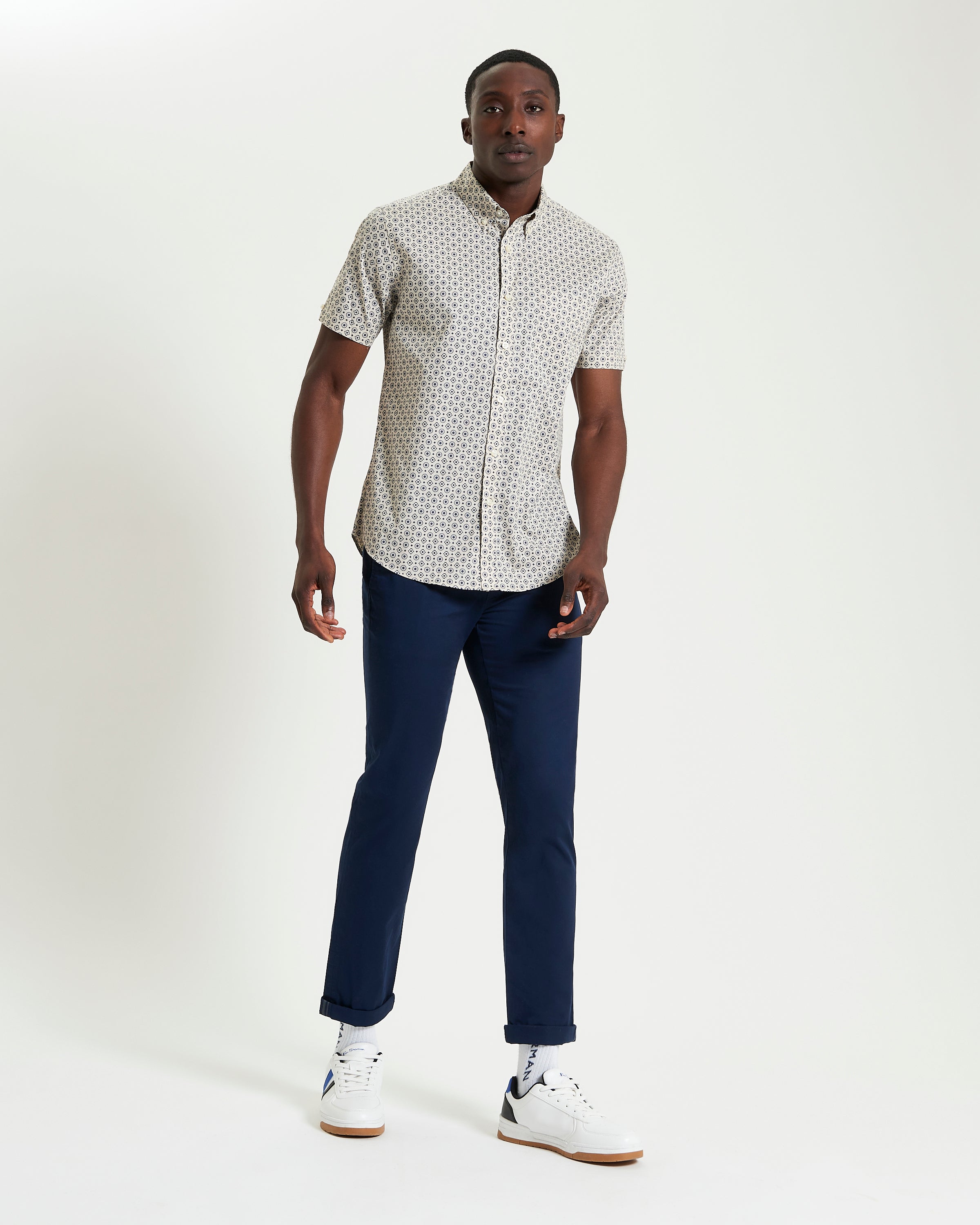 Block Geo Print short sleeve shirt styled with navy pants and white sneakers, perfect for casual and smart occasions.
