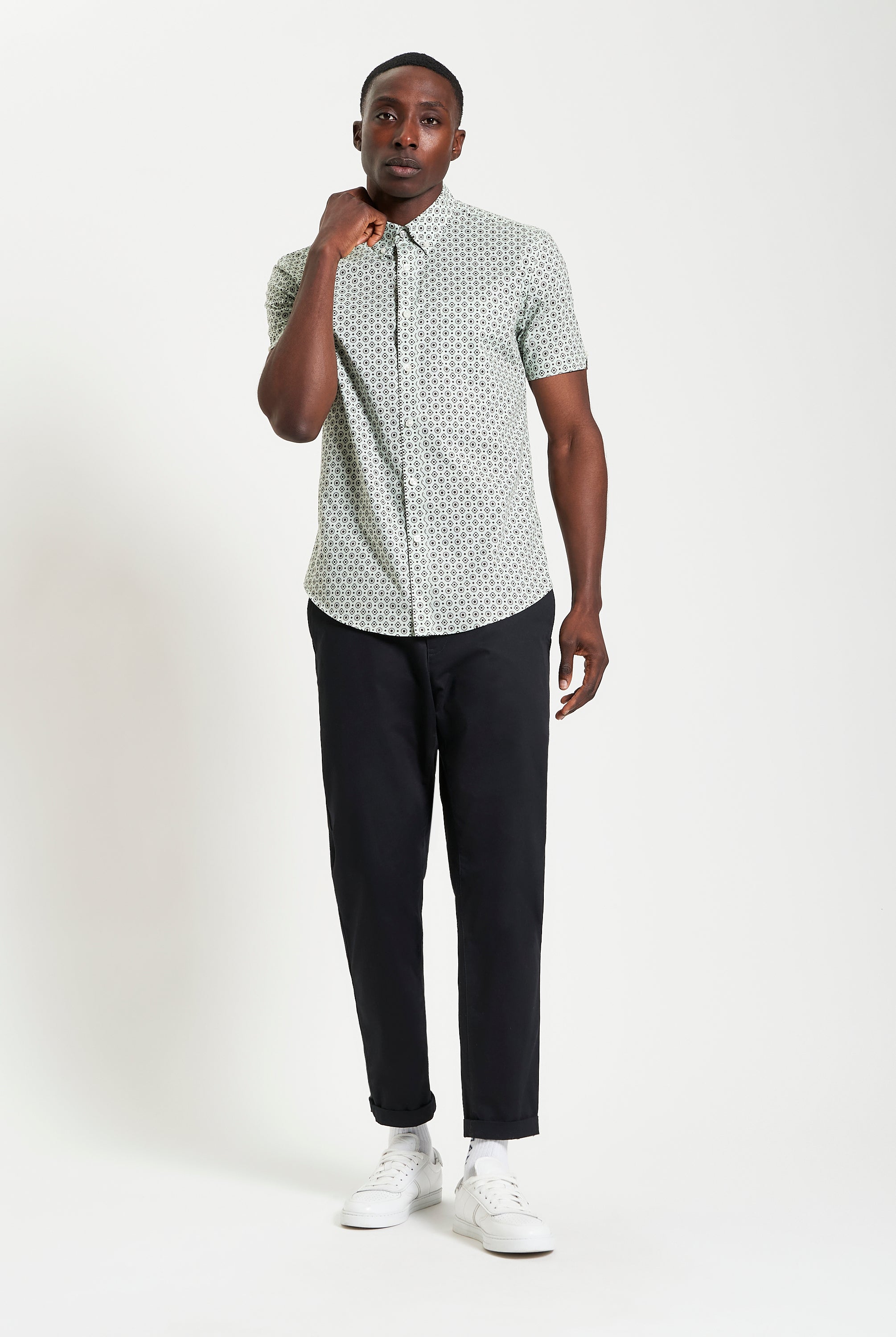 Model showcasing the Block Geo Print short sleeve shirt with stylish pants, exuding a trendy and comfortable look.