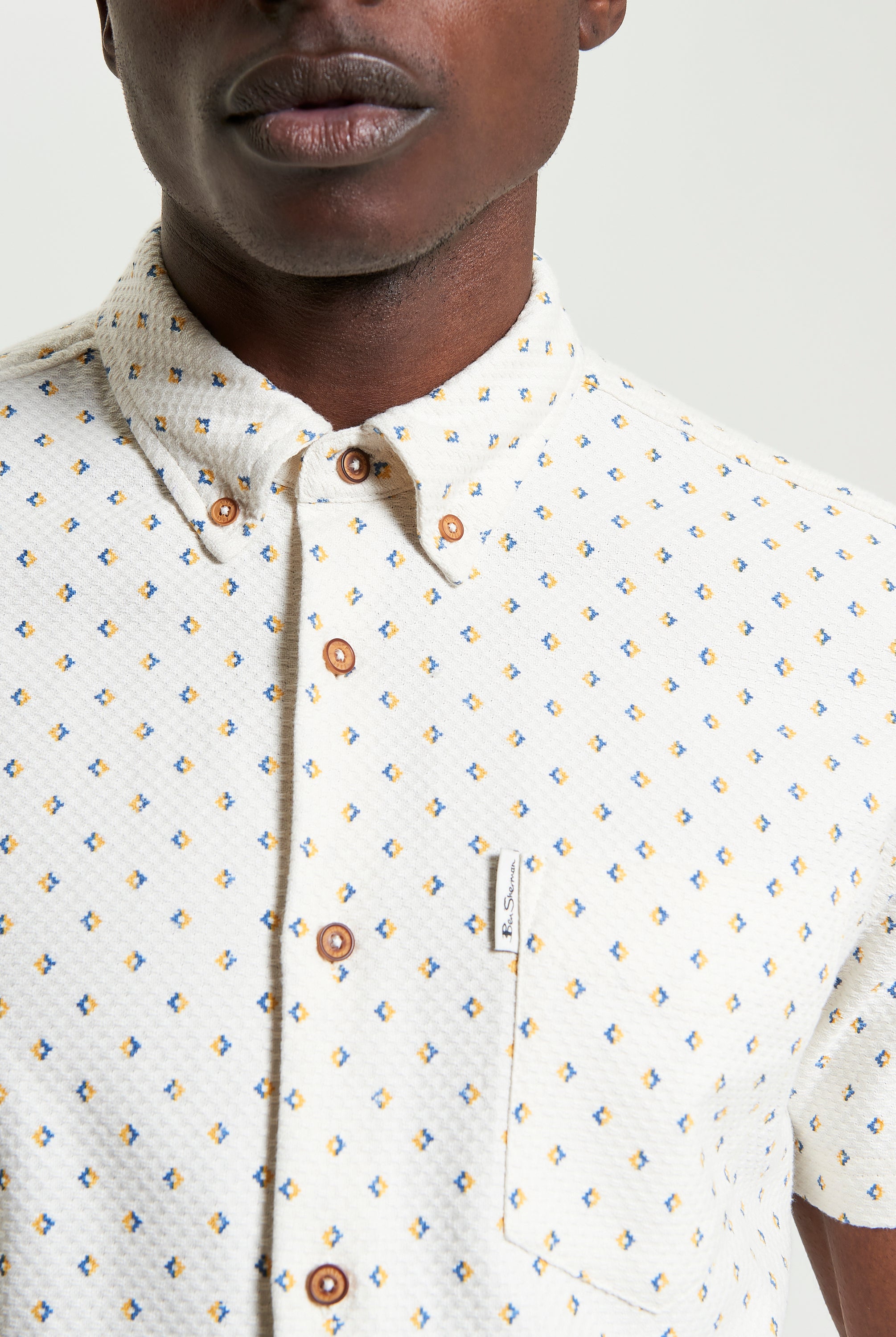 Split Geo Print short-sleeve shirt featuring a two-finger button-down collar and eye-catching pattern.