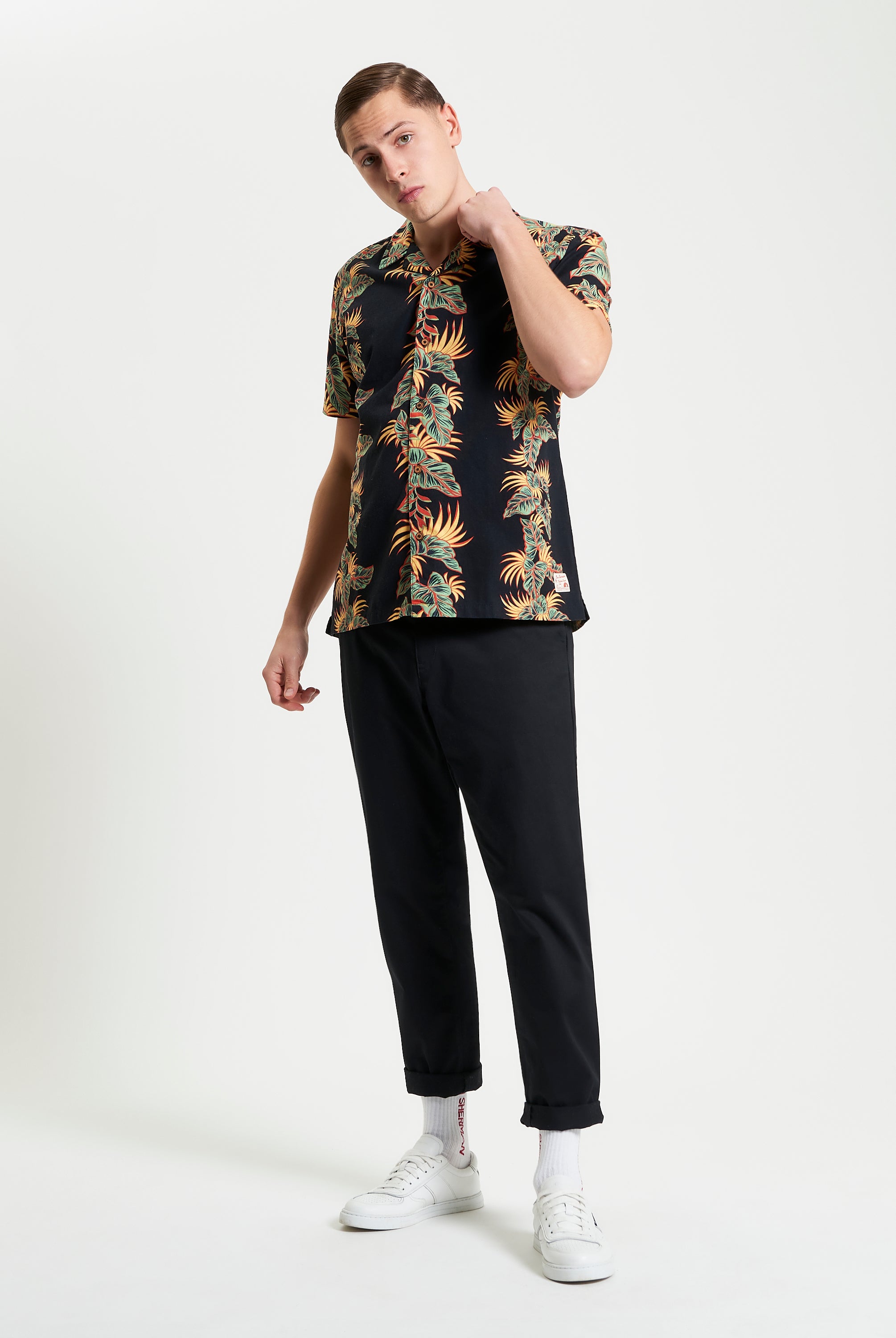 Botanical Leaf Print short sleeve shirt styled casually with black pants and white sneakers, perfect for summer.