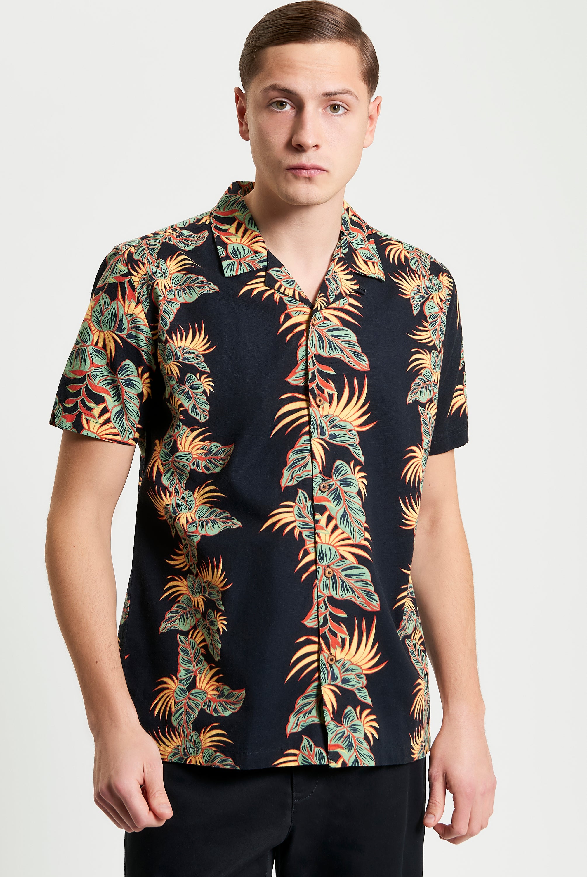Botanical Leaf Print short sleeve shirt featuring bold leaf motif and relaxed fit.
