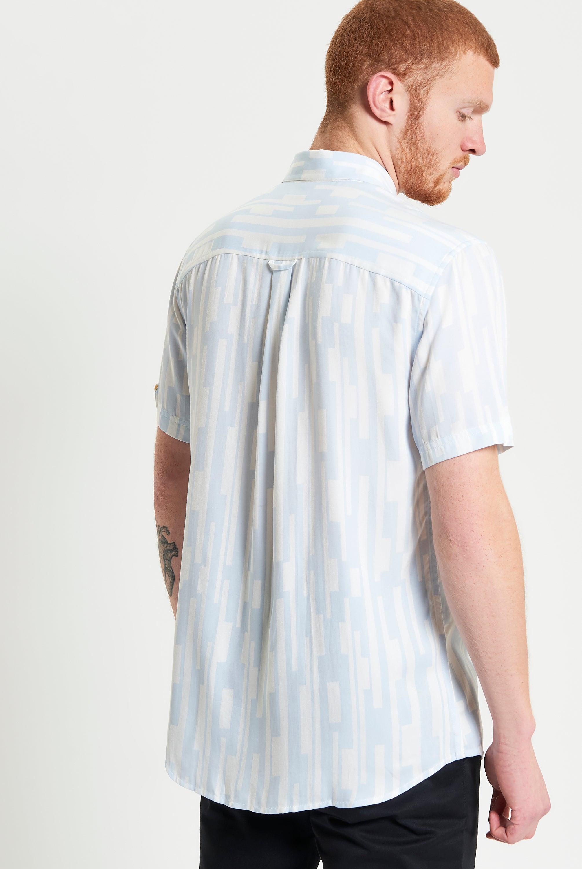 Jazz Lines Print – Back view of a stylish short-sleeve shirt featuring a contemporary abstract pattern.