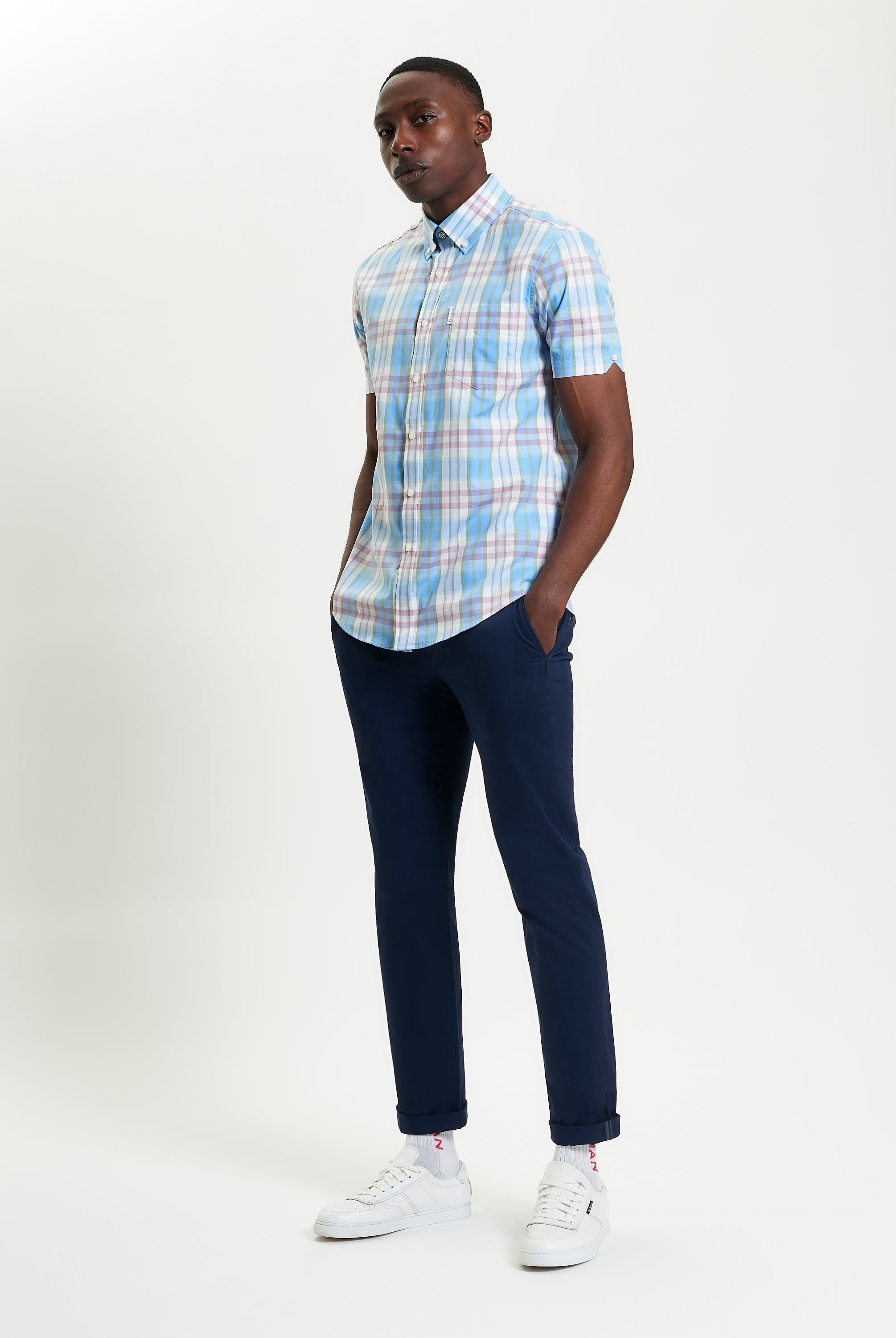 Irregular Check shirt in blue and pink plaid worn with navy pants for a stylish casual look.