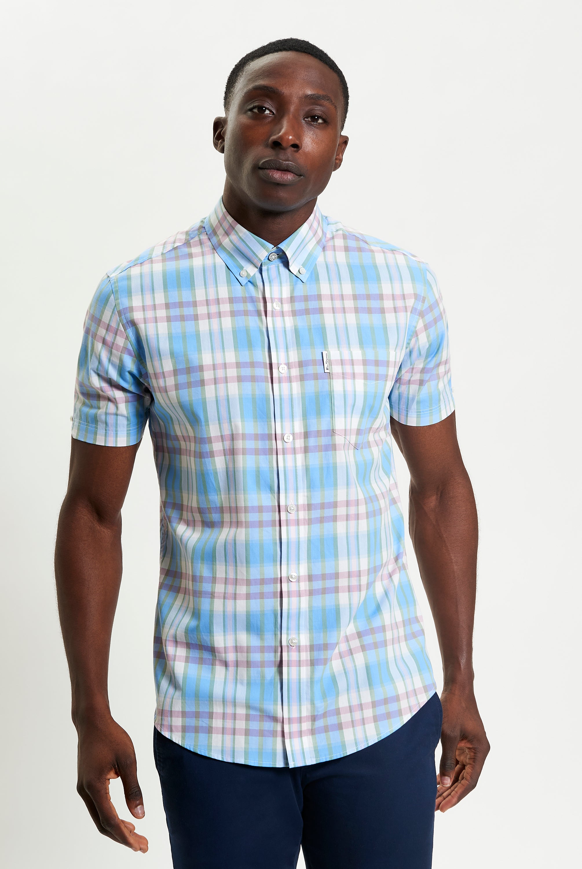 Irregular Check shirt in blue and pastel colors β short sleeve regular fit with button-down collar and curved hem.