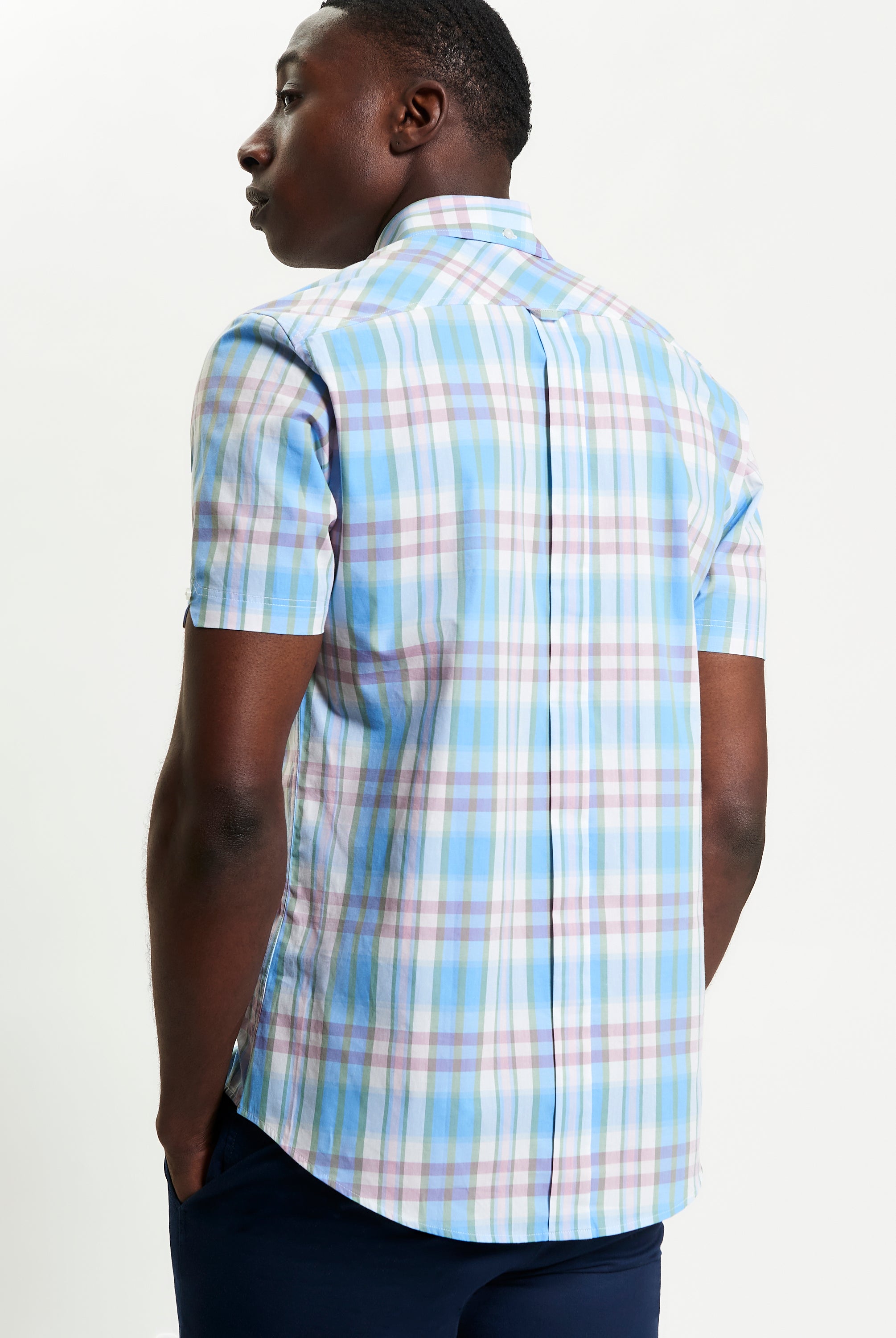 Irregular Check shirt shown from the back, featuring a blue and pastel plaid design with a curved hem.