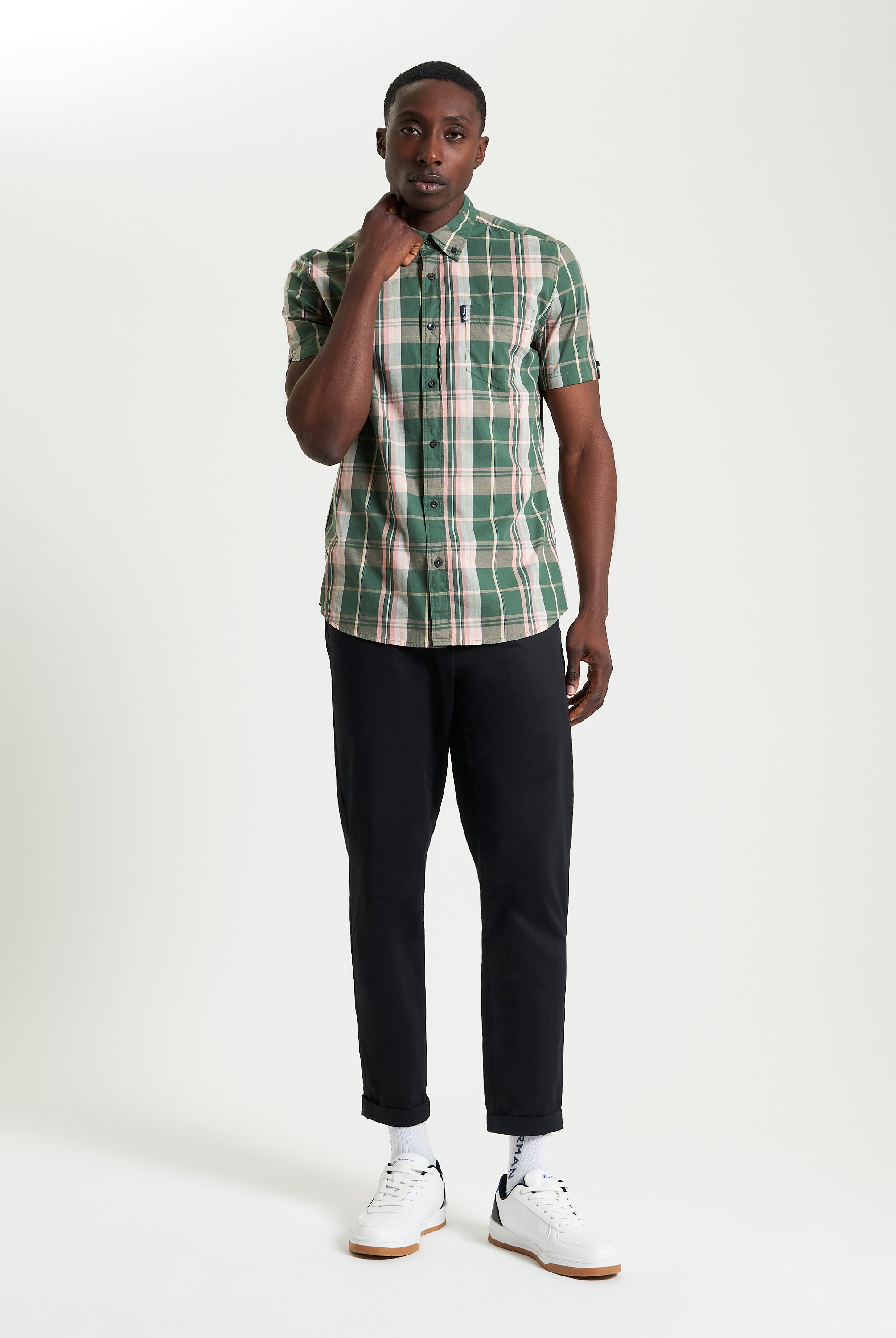 Slub Check short sleeve shirt in green plaid worn with black trousers, showcasing a casual and stylish look.