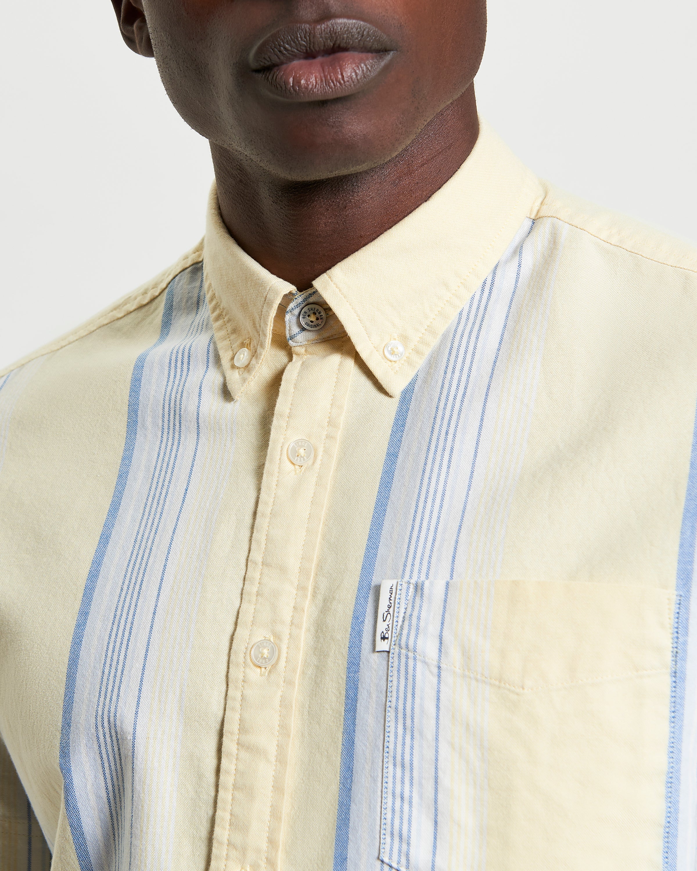 Oxford Stripe – Short sleeve shirt with blue and yellow stripes and chest pocket label.
