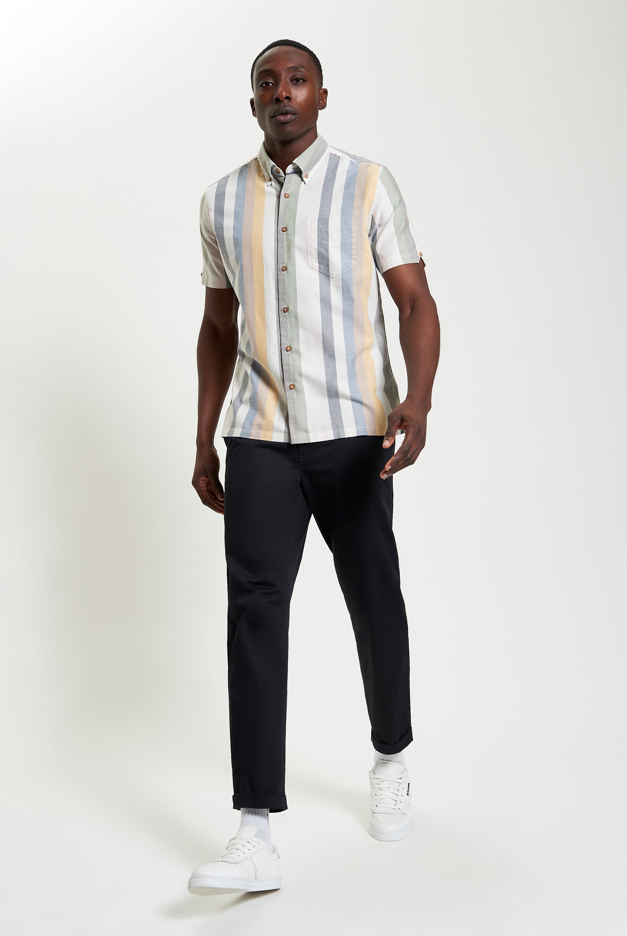 Candy Stripe shirt modeled by a man, featuring short sleeves and a straight hem, perfect for warm weather style.