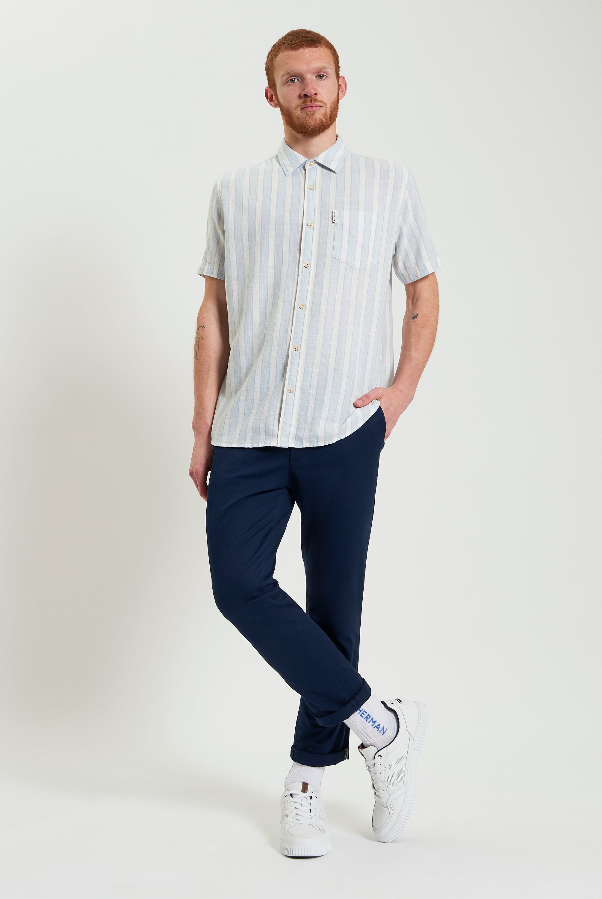 Framed Candy Stripe short sleeve shirt in light blue stripes paired with navy pants, perfect for a casual summer look.