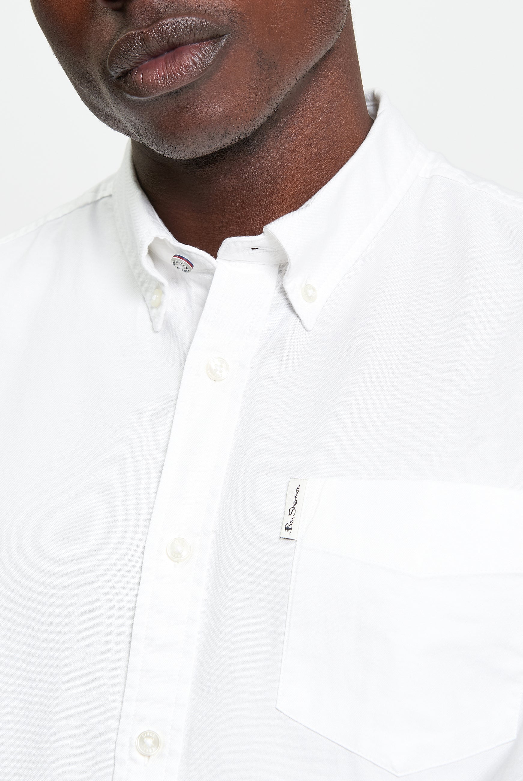 Signature Oxford Short Sleeve Shirt β White β featuring a button-down collar and chest pocket with woven label.