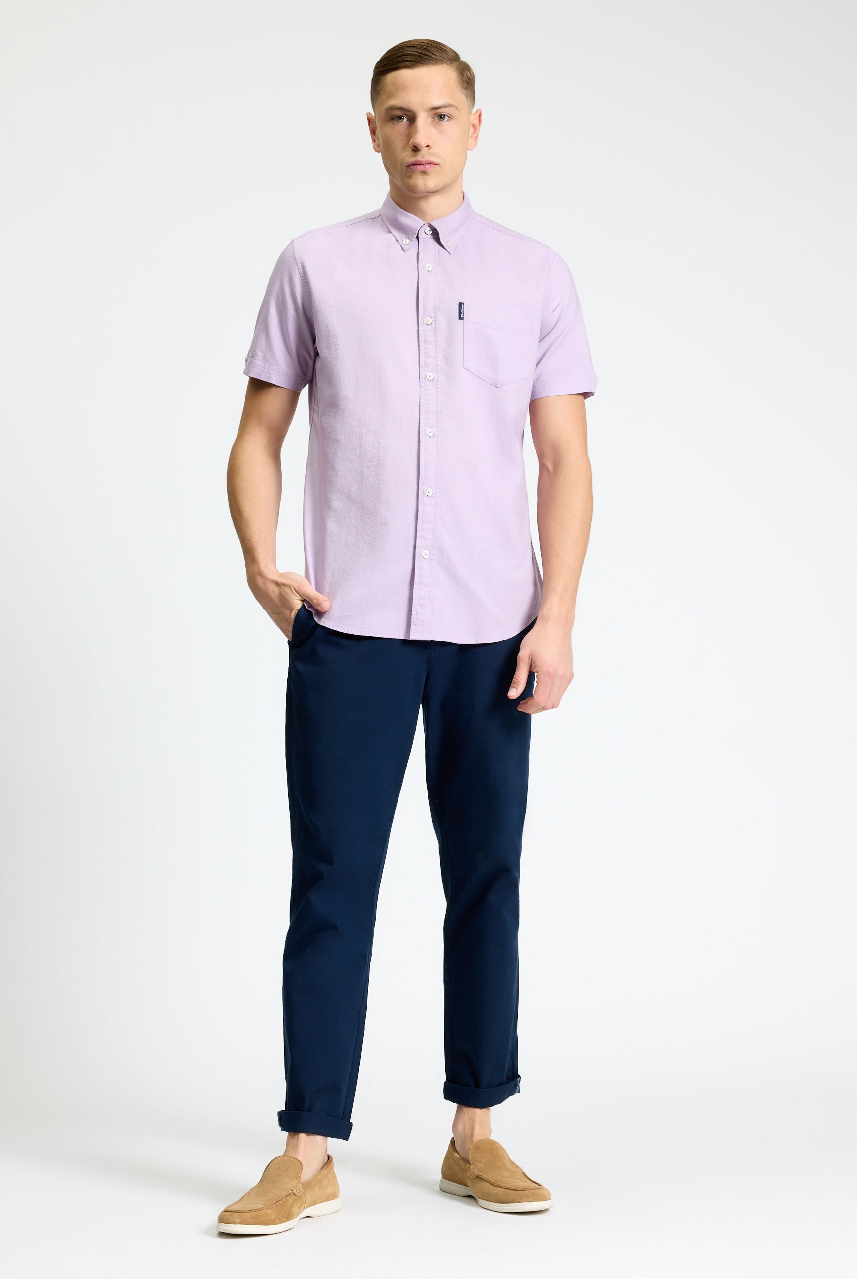 Model wearing Signature Oxford Short Sleeve Shirt in lavender with navy pants and tan shoes.