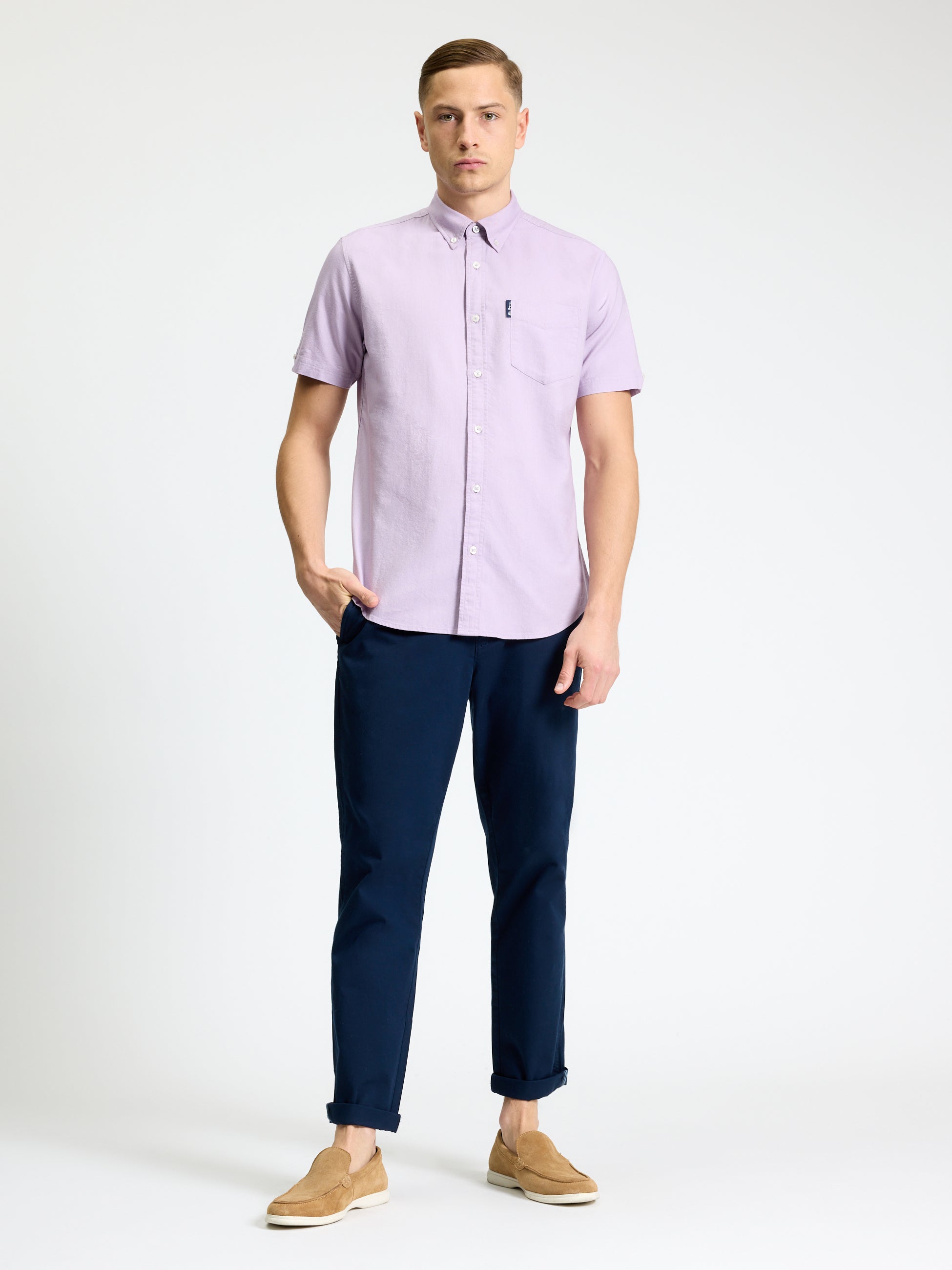 Model wearing Signature Oxford Short Sleeve Shirt in lavender with navy pants and tan shoes.