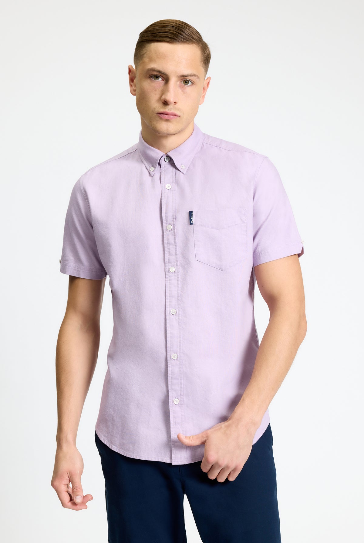 Signature Oxford Short Sleeve Shirt – lightweight purple shirt on model with button-down collar and chest pocket.