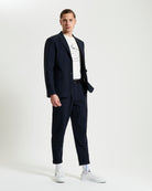 Seersucker Trouser – navy – slim fit with elasticated waistband and four pockets, styled with blazer and white sneakers.