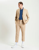 Linen Cotton Trouser – beige slim fit paired with a blue polo shirt and beige blazer, styled for warm weather elegance.