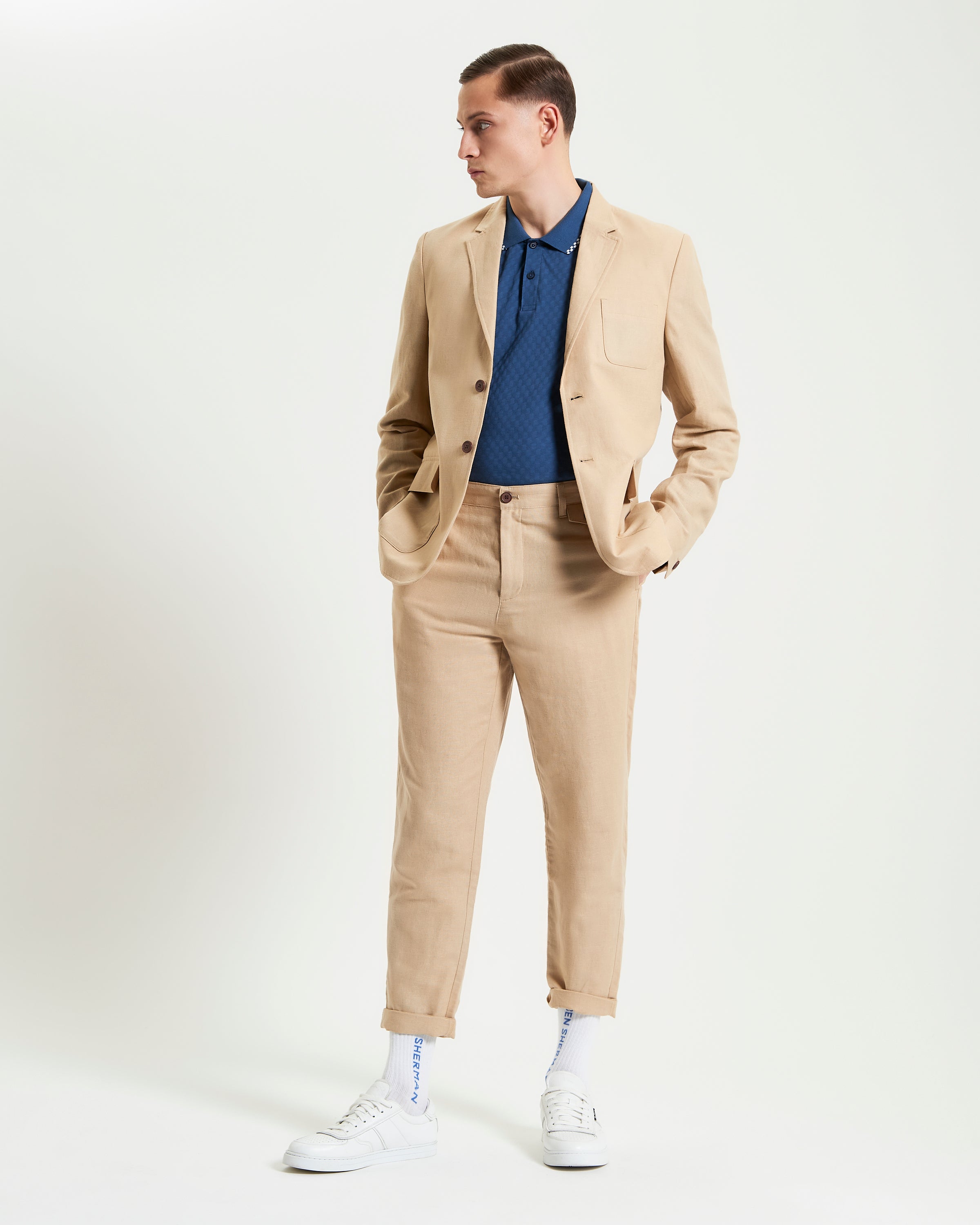 Linen Cotton Trouser – beige slim fit paired with a blue polo shirt and beige blazer, styled for warm weather elegance.