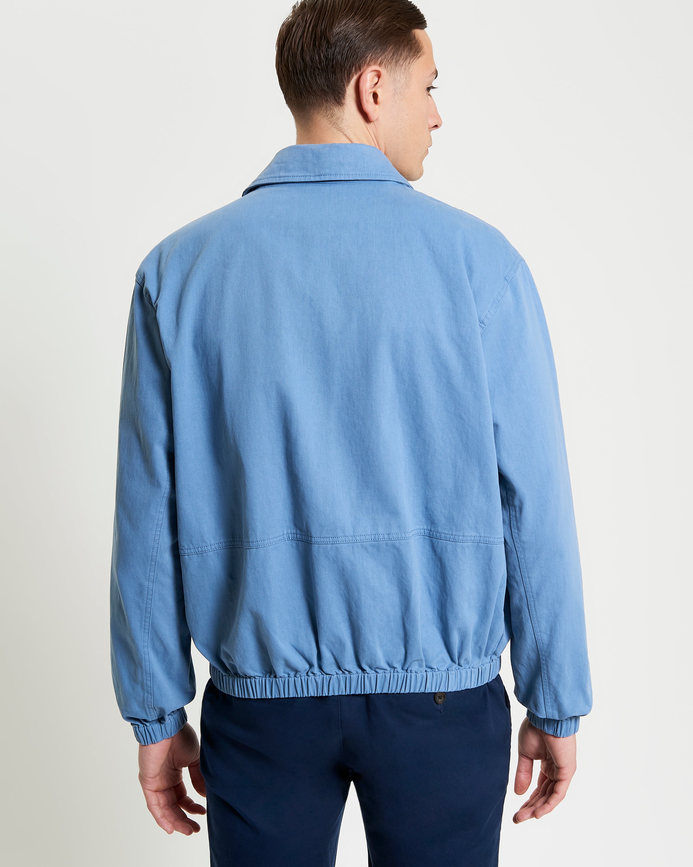 Sports Blouson – blue jacket with elasticated hem and cuffs, viewed from the back