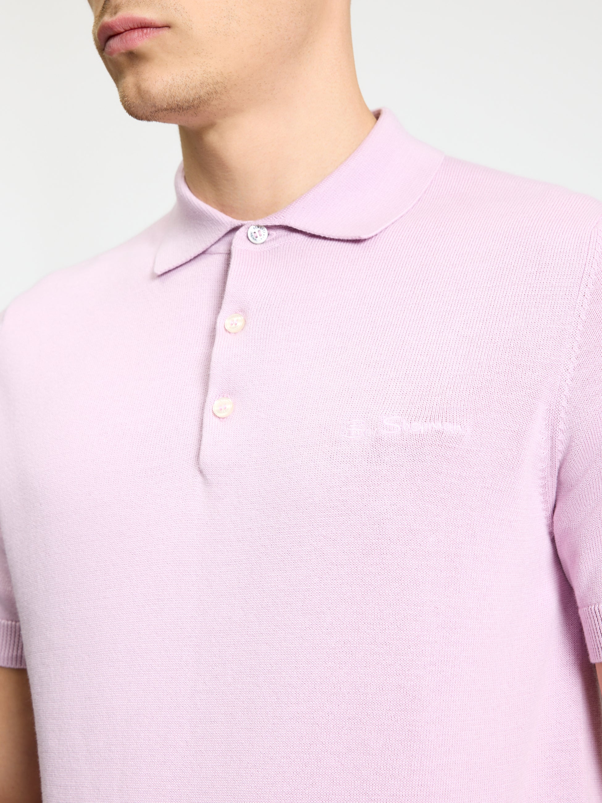 Signature Short Sleeve Polo – light purple color featuring ribbed collar and cuffs, model showcasing a casual look.