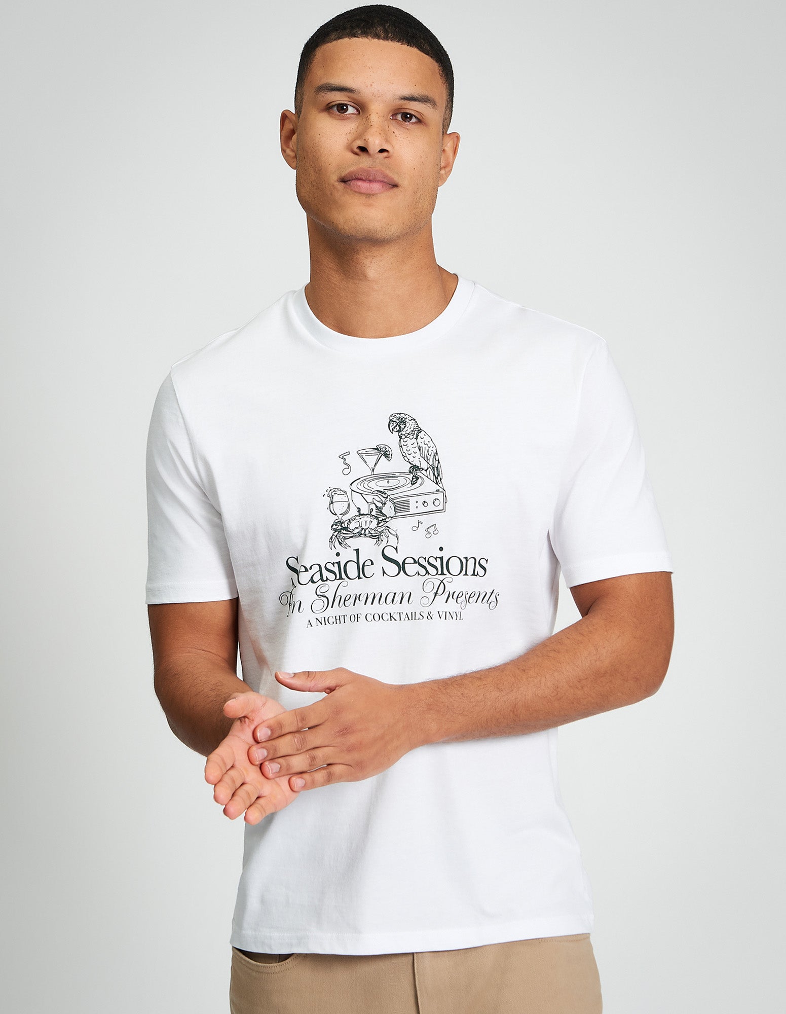 Model wearing Seaside Sessions Tee with graphic print, showcasing style and comfort in organic cotton.
