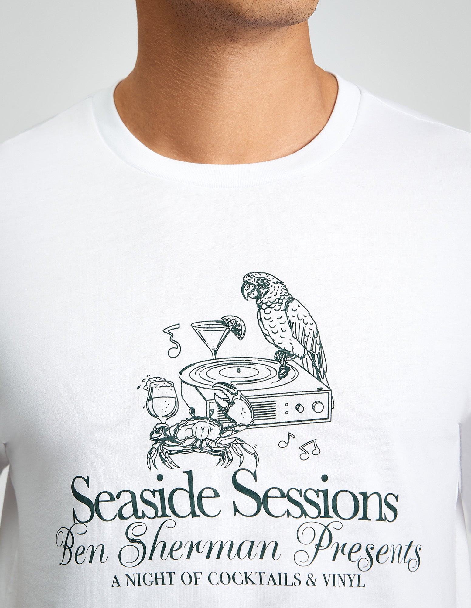Seaside Sessions Tee featuring a graphic print of a parrot, crab, and cocktail on a white shirt by Ben Sherman.