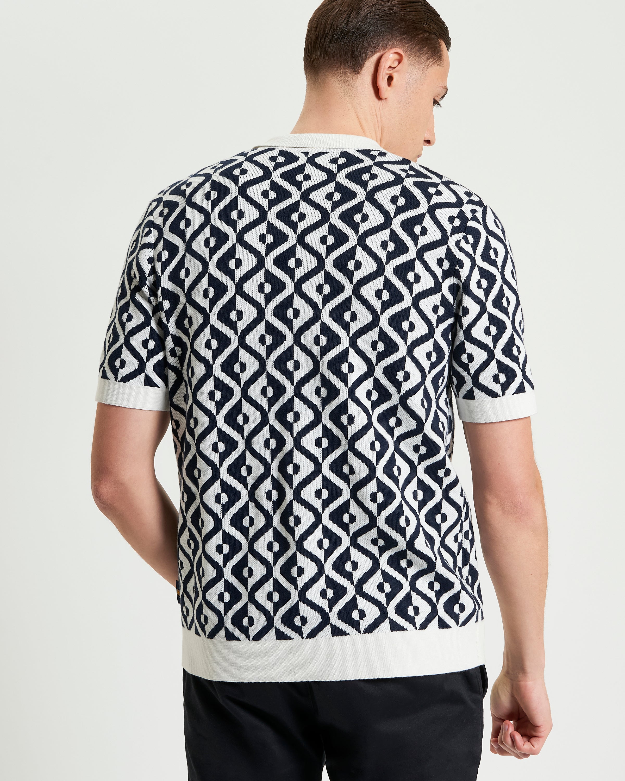 Back view of a man wearing the Tile Resort Knitted Shirt featuring a tile jacquard knit design.