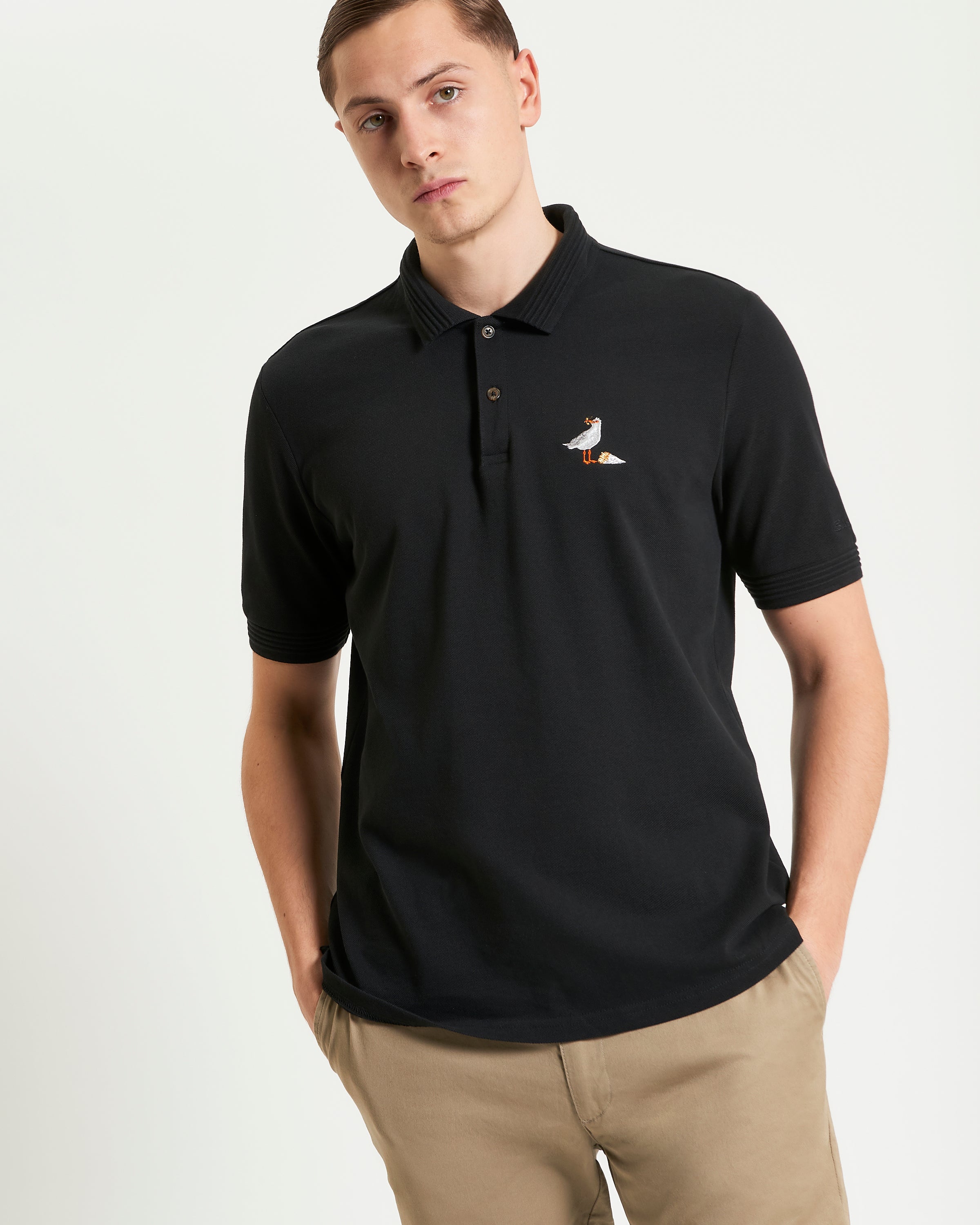 Gull Embroidery Polo – relaxed fit pique polo in black with gull embroidery and ribbed collar.