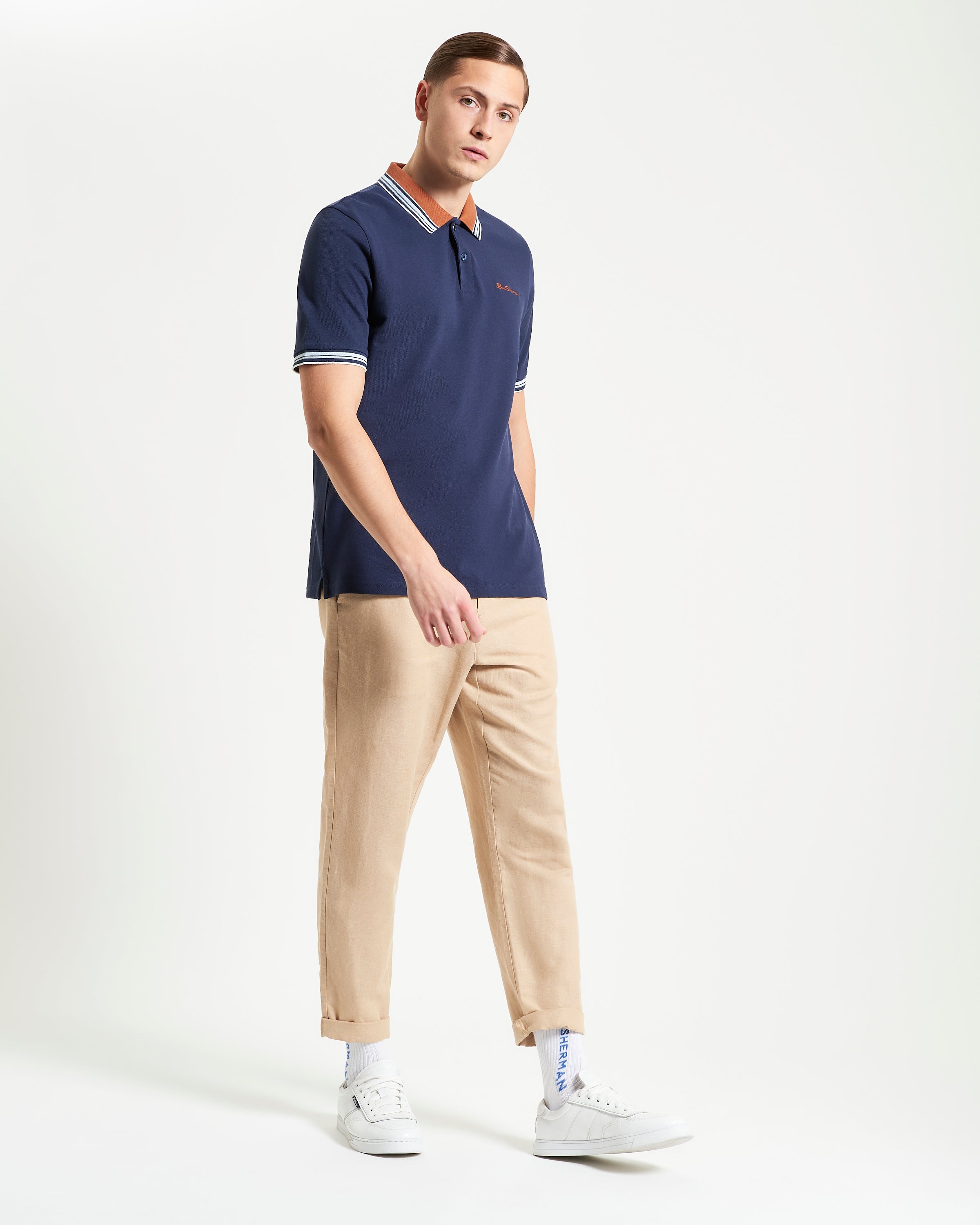 House Collar Polo – Navy with contrast stripe tipping on collar and cuffs, featuring a two button placket.