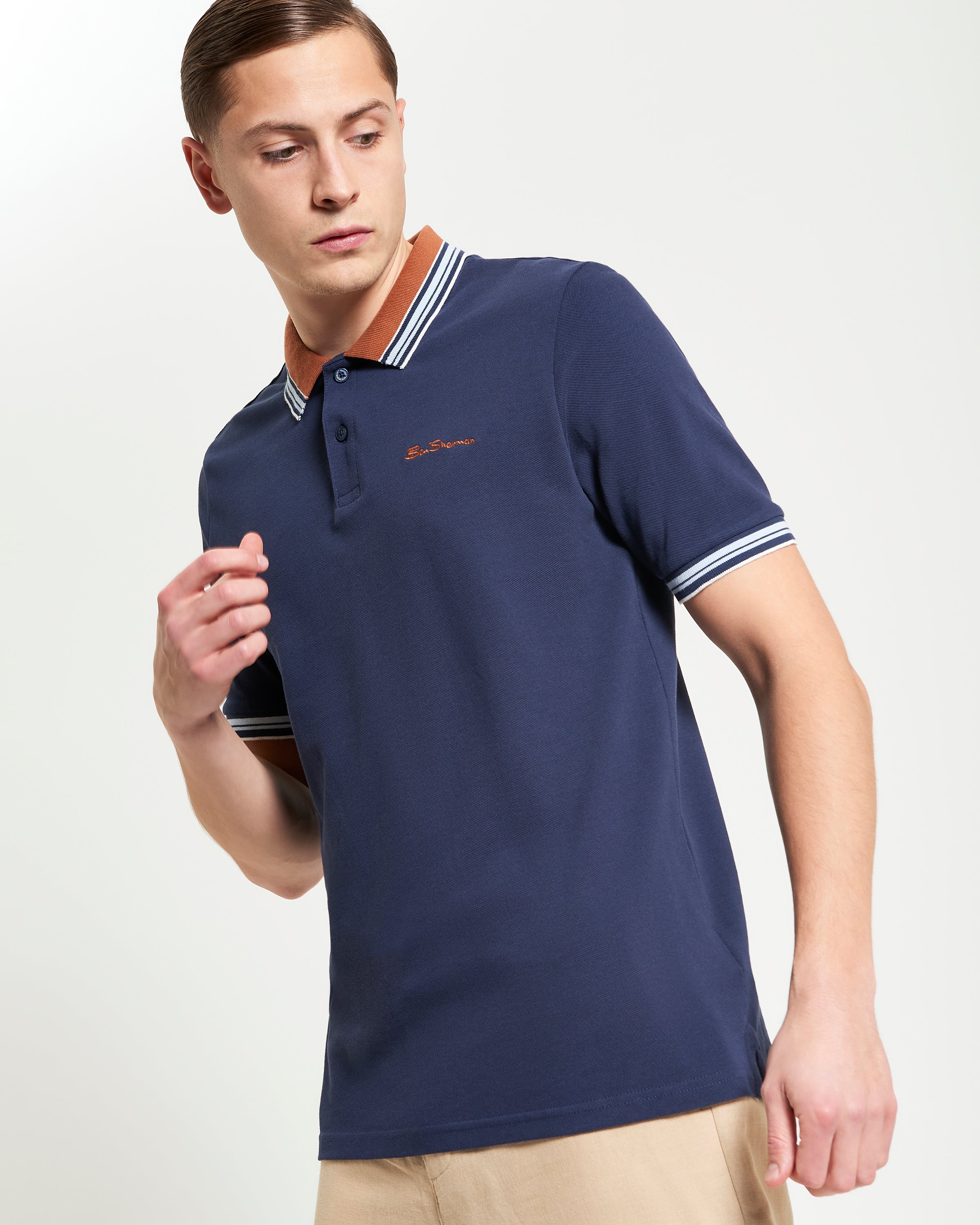 House Collar Polo – navy blue with contrast stripe tipping at collar and cuffs, two button placket, men's casual wear.
