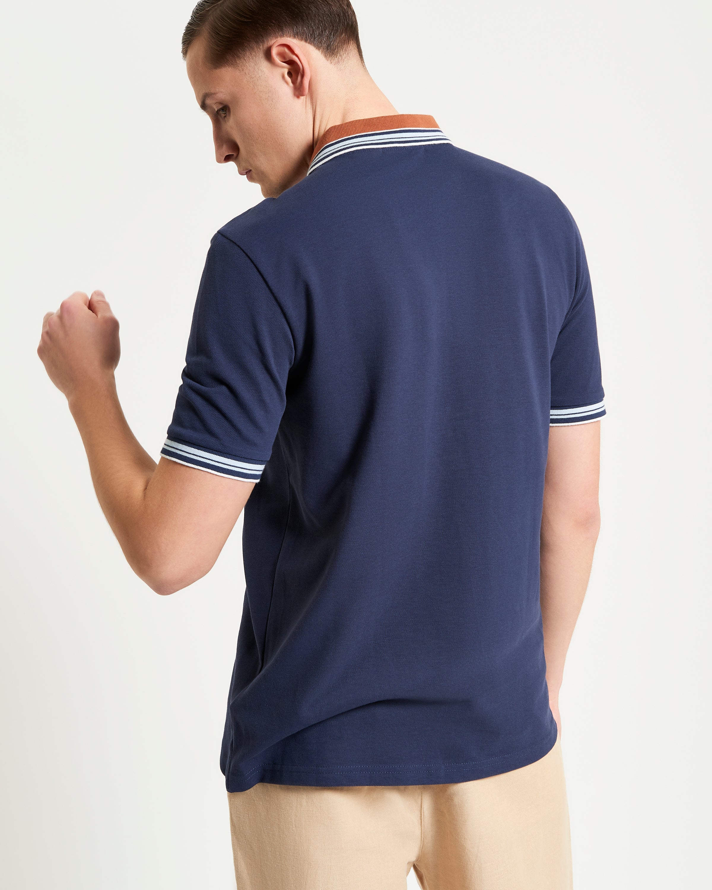 House Collar Polo – navy blue with contrast stripe tipping on collar and cuffs, showcasing a relaxed fit and classic detailing.