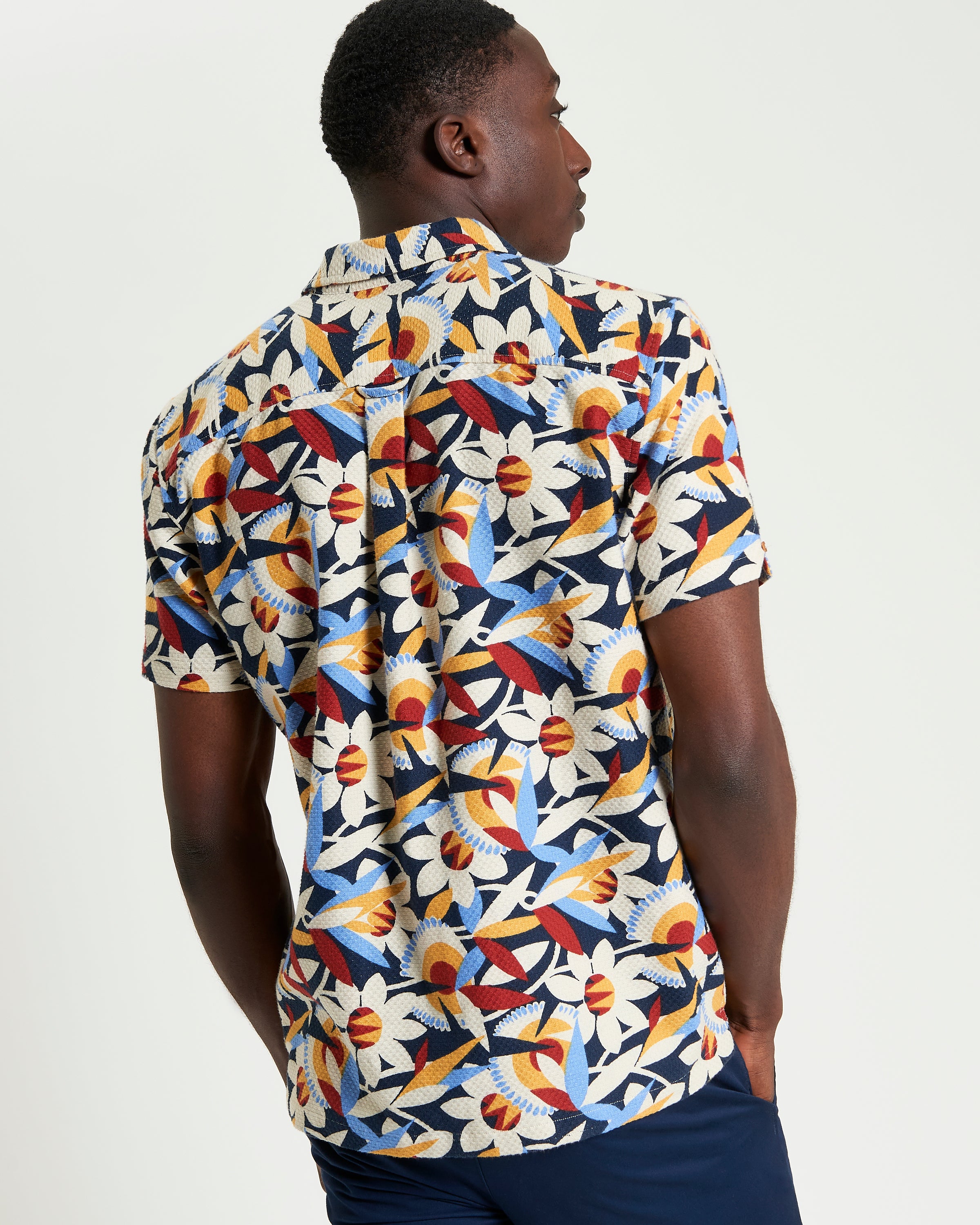 Abstract Floral Print – Short-sleeve shirt with colorful floral pattern and revere collar, perfect for summer styling.