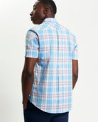 Irregular Check shirt shown from the back, featuring a blue and pastel plaid design with a curved hem.