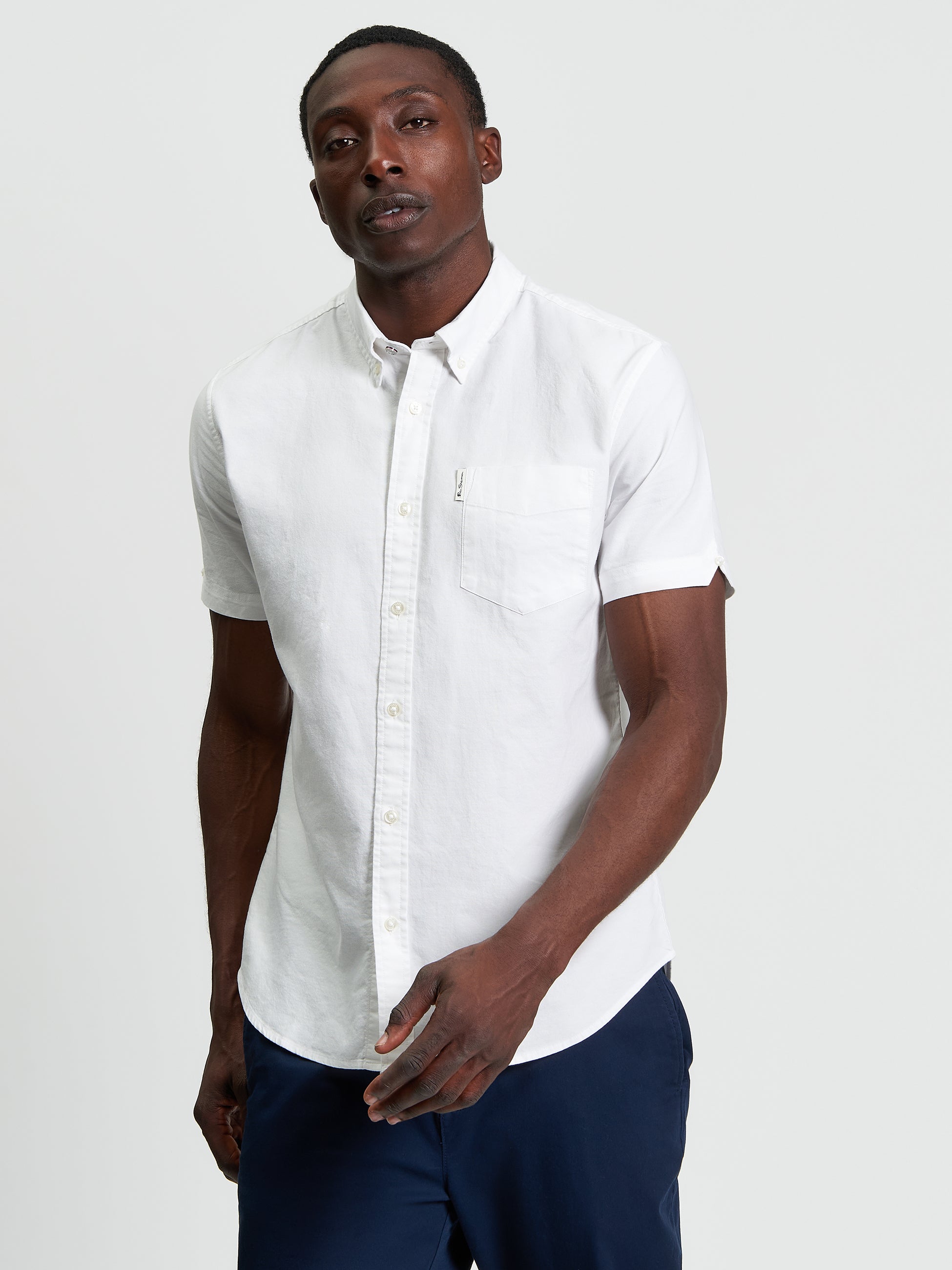 Signature Oxford Short Sleeve Shirt – White with short sleeves and chest pocket.
