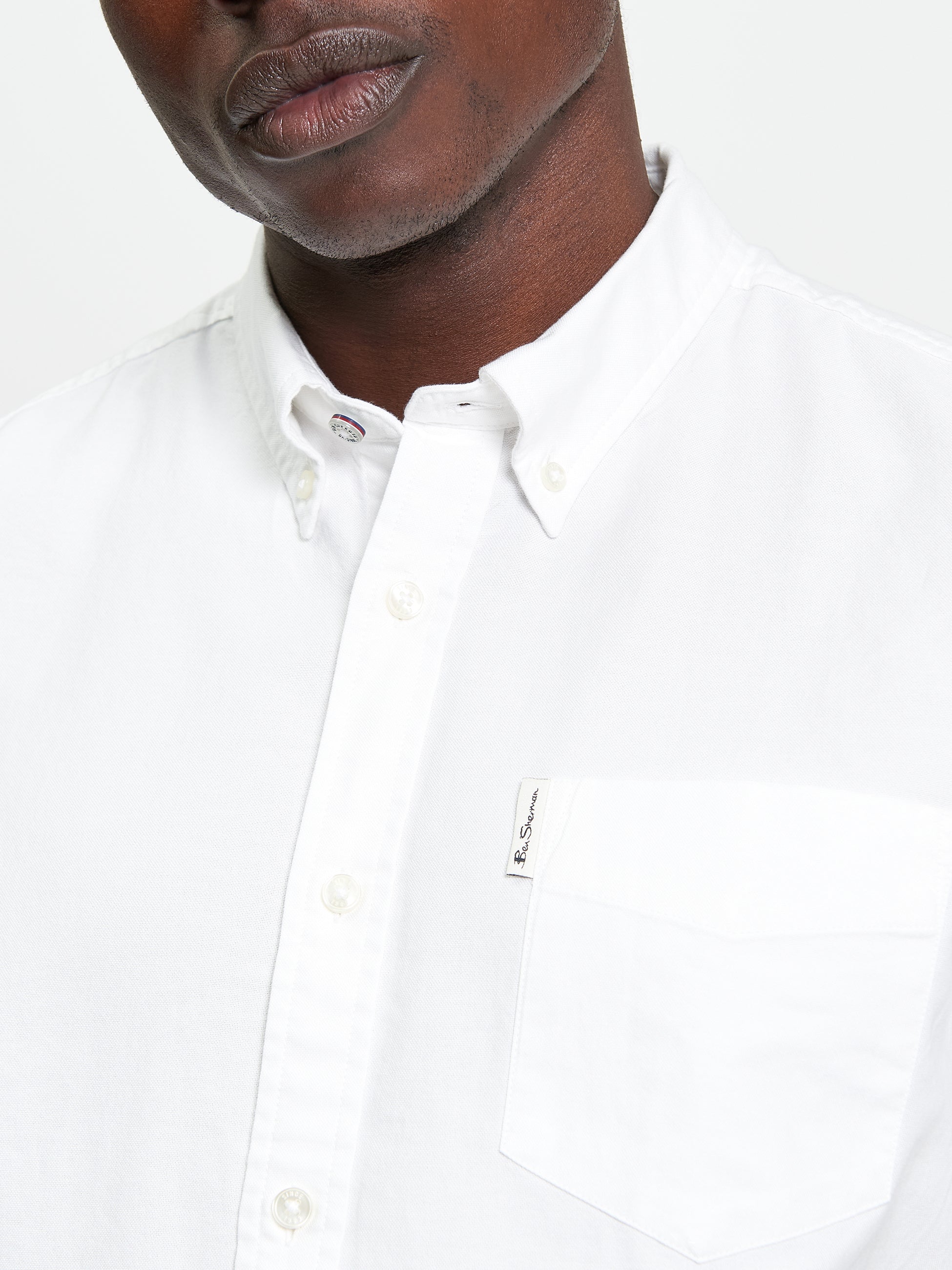 Signature Oxford Short Sleeve Shirt – White – featuring a button-down collar and chest pocket with woven label.