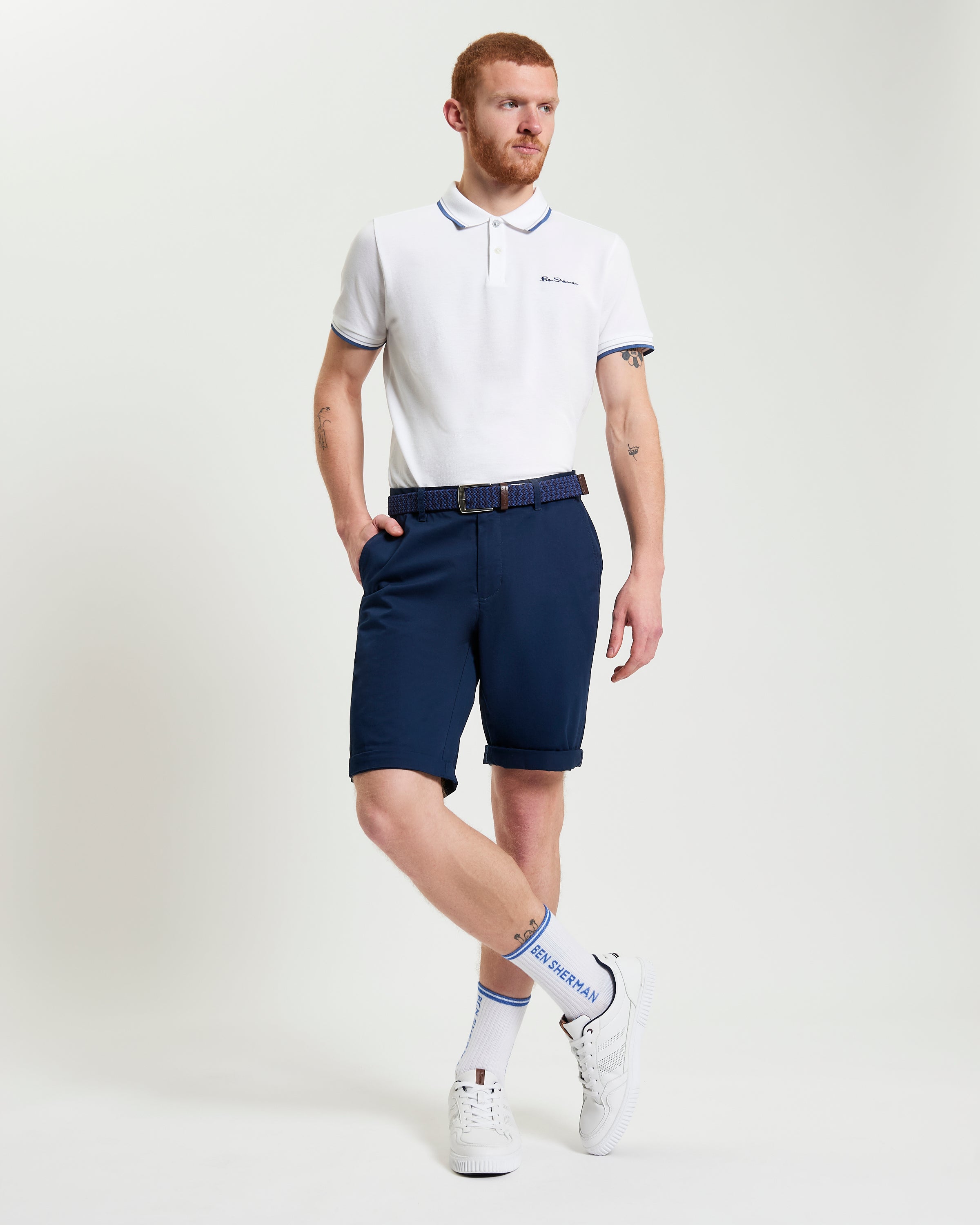 Man wearing Signature Chino Short in navy with a polo shirt, showcasing summer style and comfort.