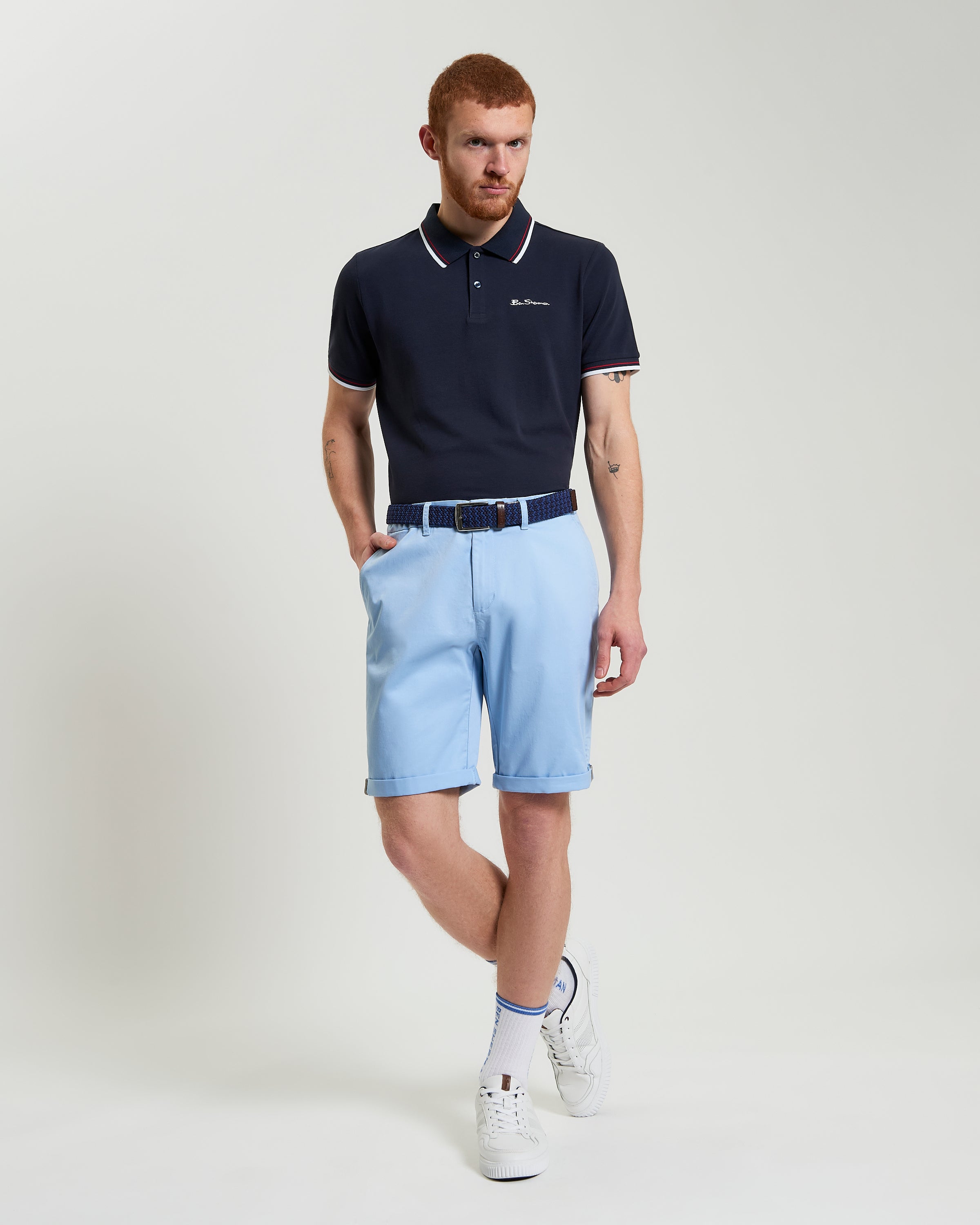 Model wearing Signature Chino Short in light blue with a navy polo, showcasing summer style and comfort.