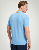 Signature Pique Polo – Back view of a man wearing a light blue polo shirt featuring contrast detailing.