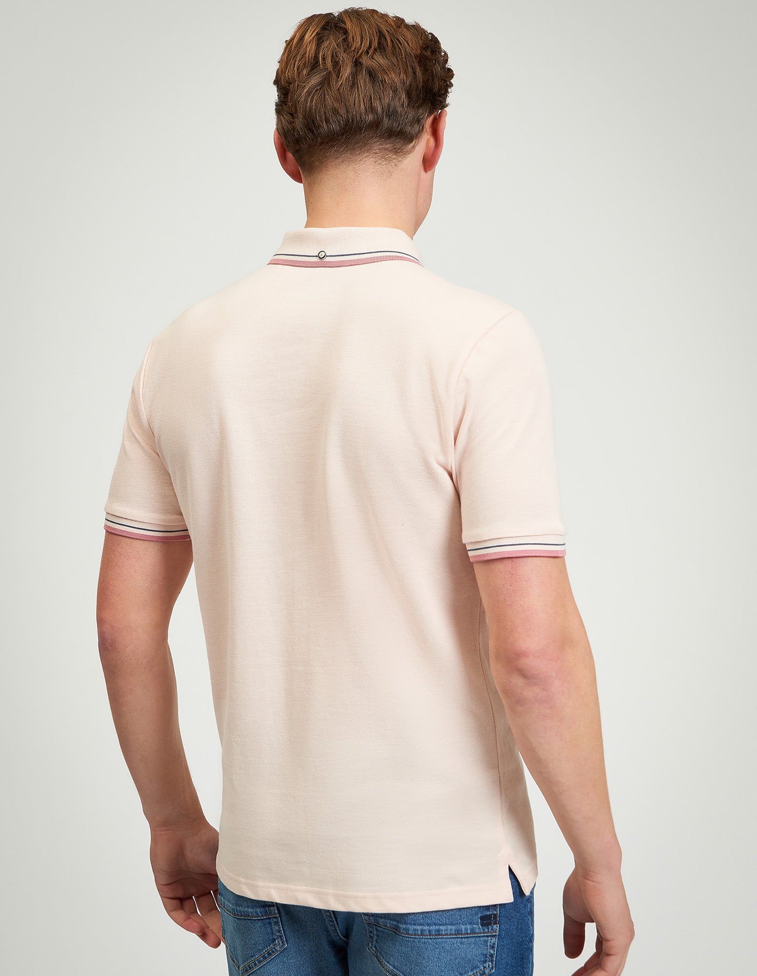 Signature Pique Polo – back view with contrast detailing on collar and sleeves in soft pink.
