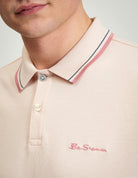 Close-up of a man's neck and collar wearing the Signature Pique Polo with contrast detailing.