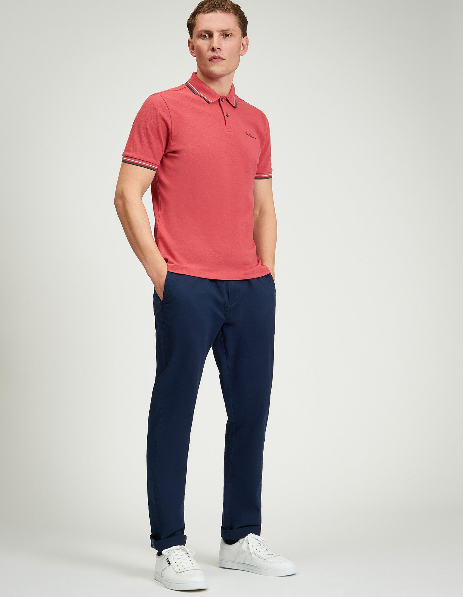 Signature Pique Polo – refined casual wear model in a pink polo and navy pants.