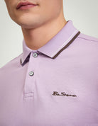 Signature Pique Polo – lilac color close-up showing logo and collar detail.