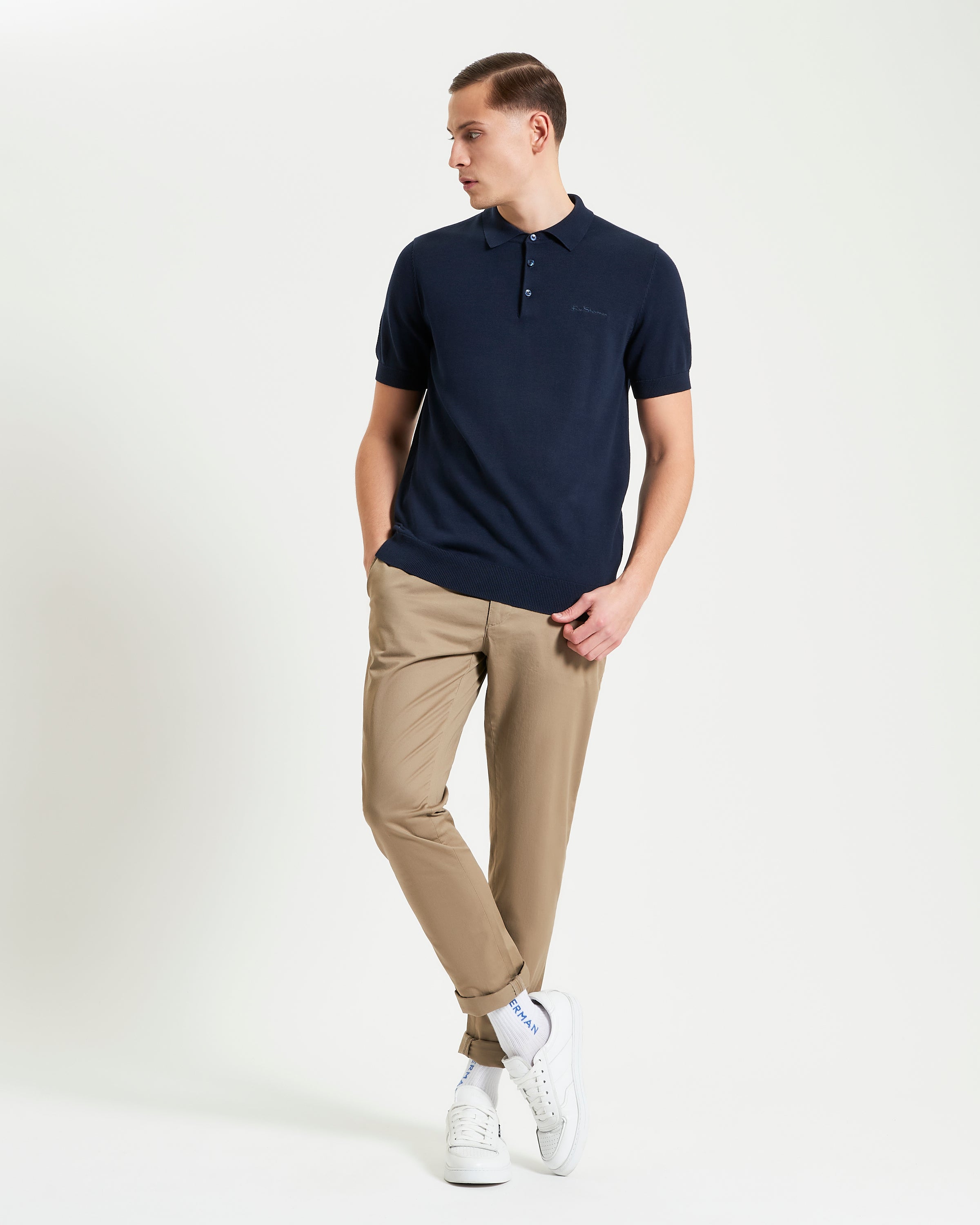 Signature Short Sleeve Polo – navy blue, styled with beige pants and white sneakers for a casual look.
