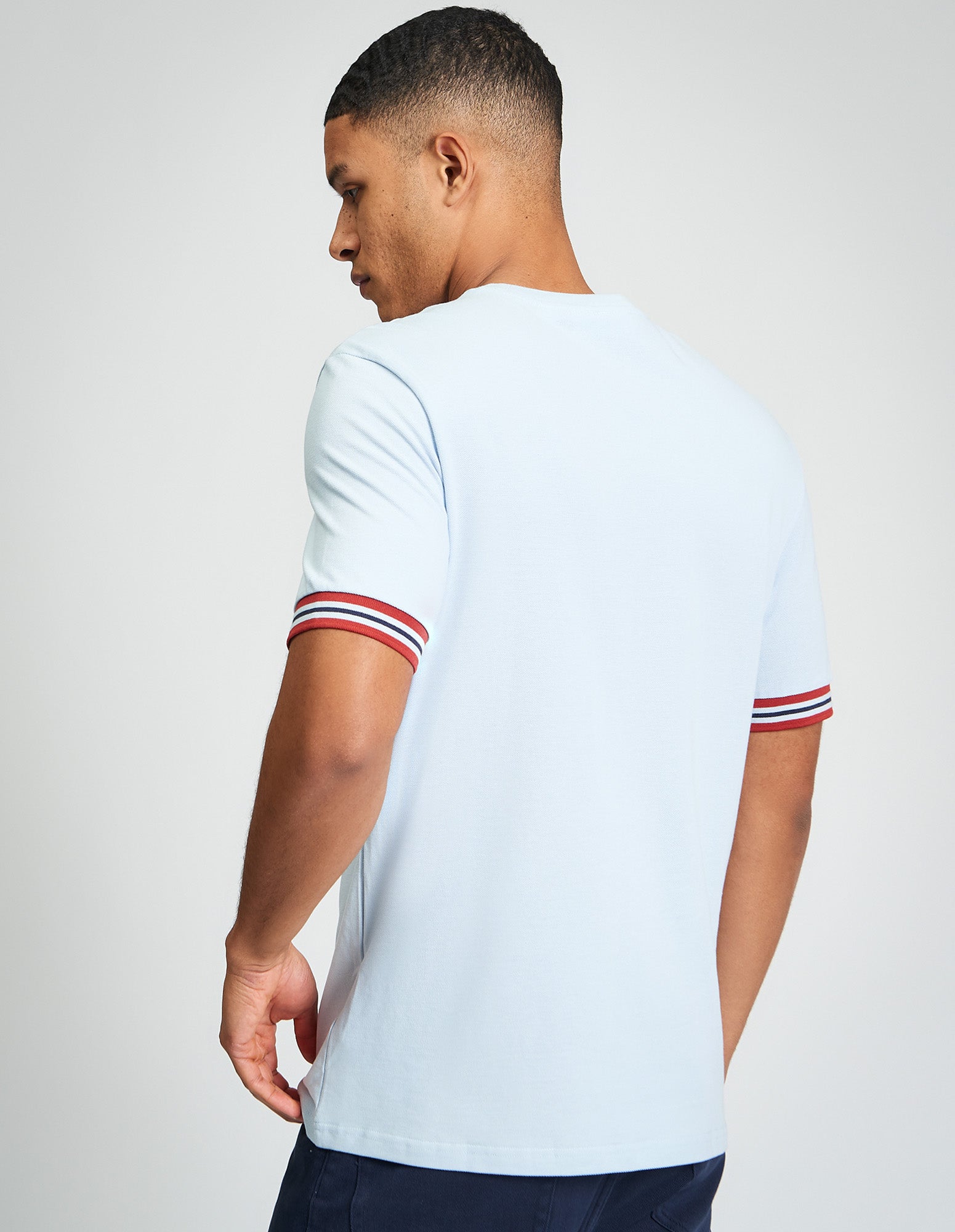 Pique Tipped Tee – back view showcasing contrast colour-block cuffs and relaxed fit in light blue.