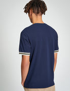 Pique Tipped Tee – back view showcasing navy color and contrast striped cuffs on a relaxed-fit style.